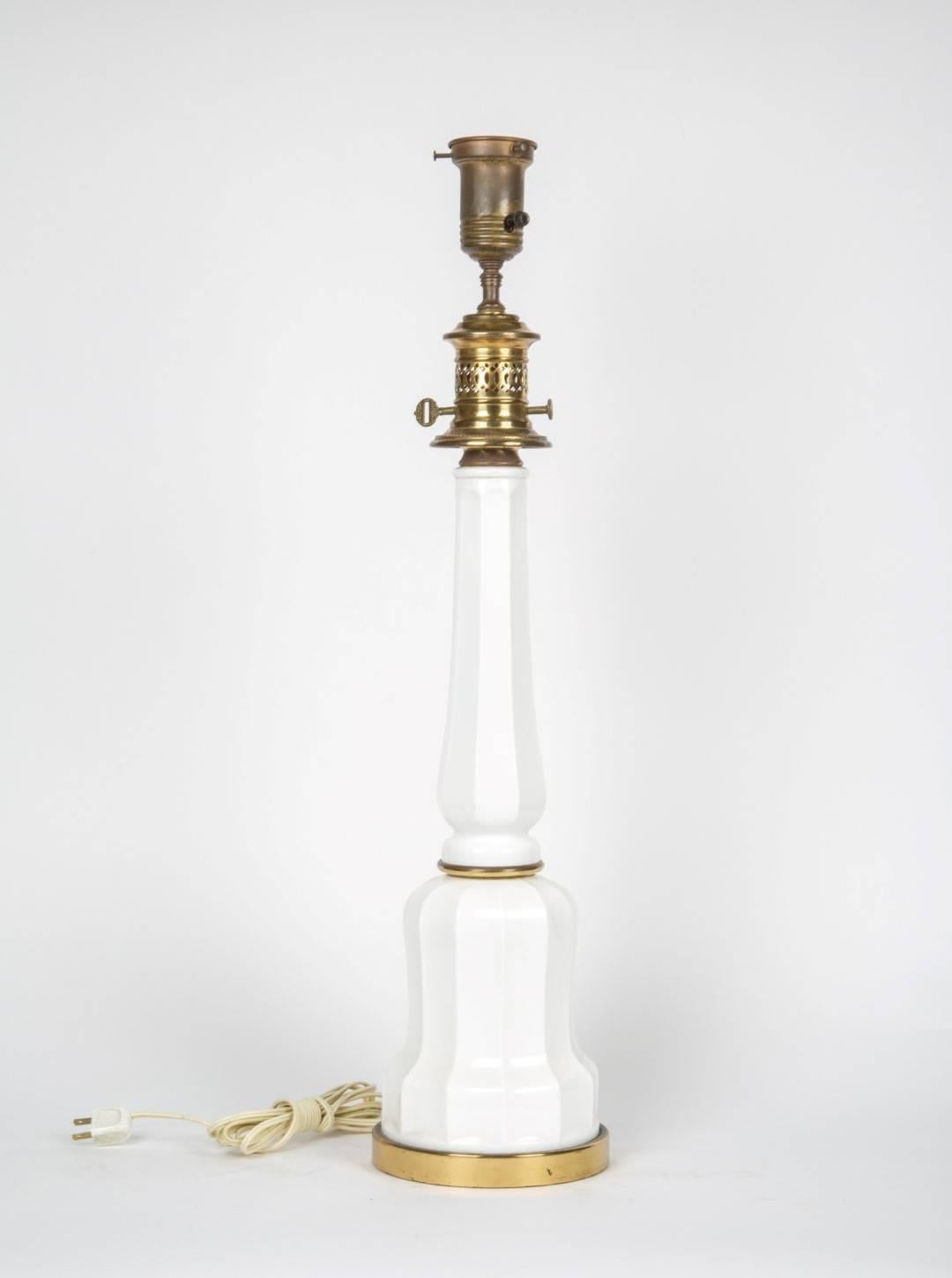 A pair of opaline glass table lamps having oil form design with brass fittings.
