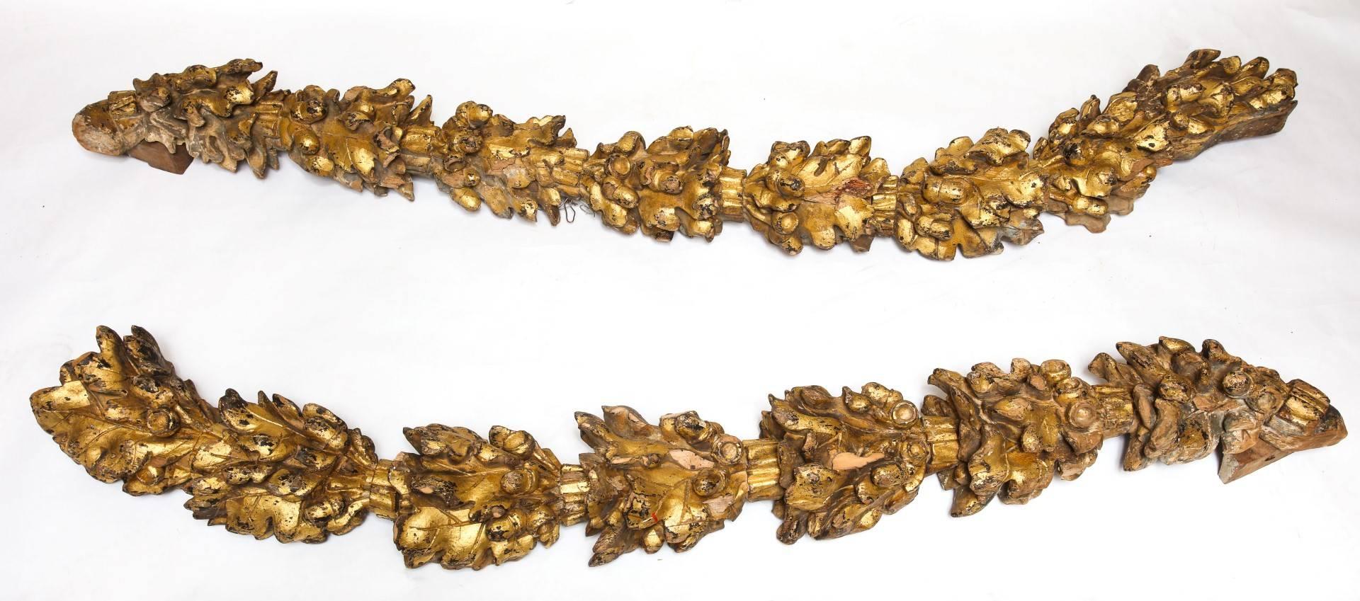 A pair of George III giltwood hand-carved oak leaf and acorn decorative garlands.