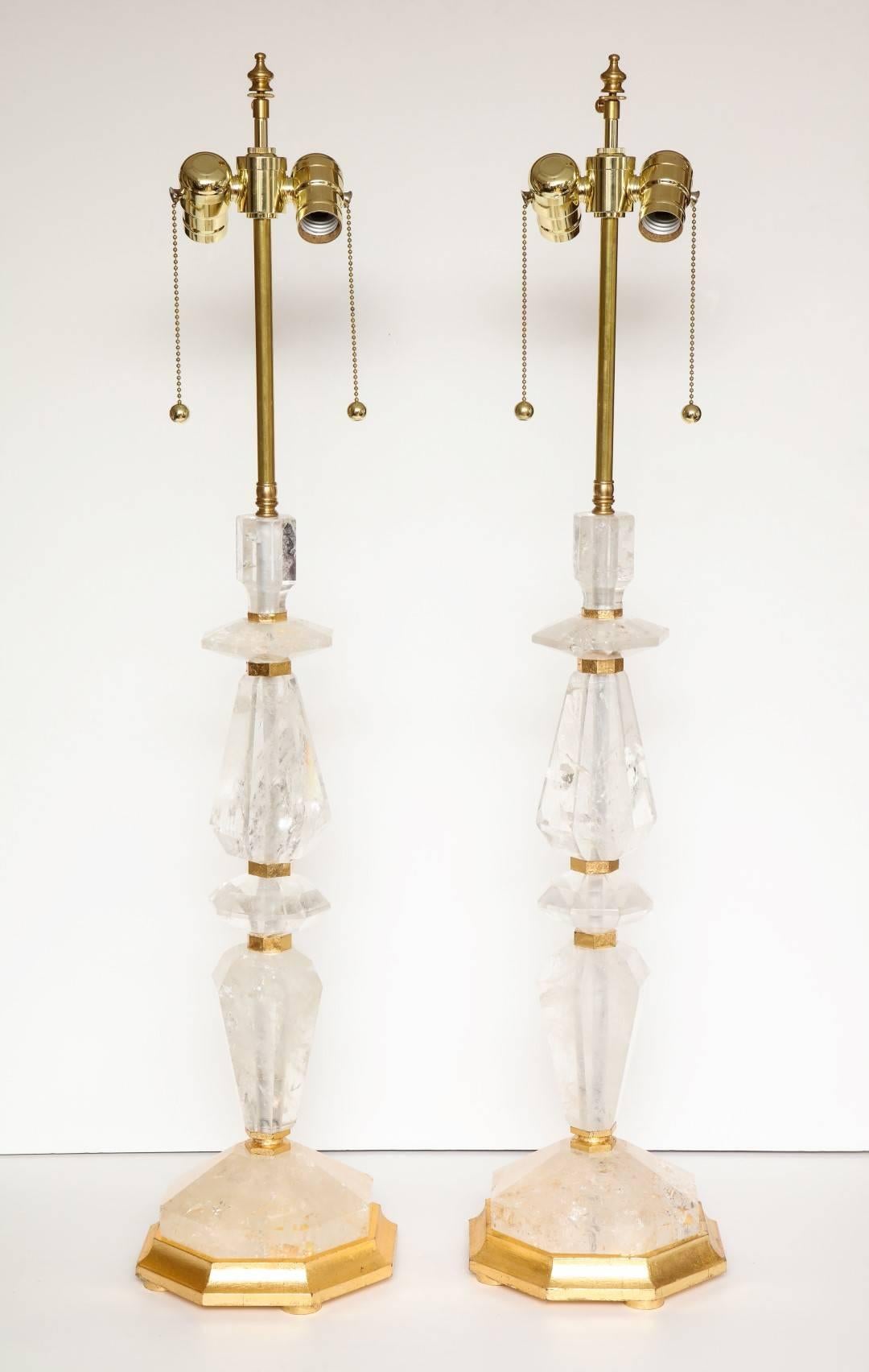 A pair of new rock crystal table lamps, giltwood elements, wired for electricity.
