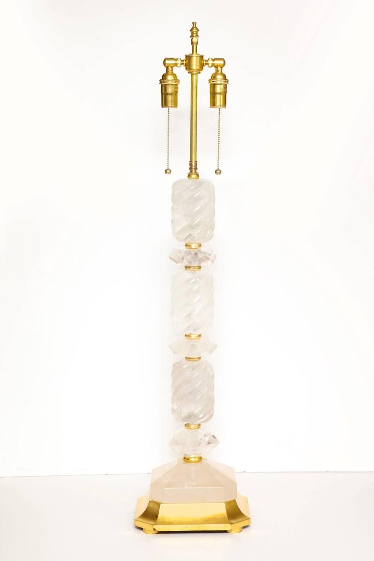 A pair of new rock crystal table lamps, stacked rock crystal elements with giltwood fittings and square base.