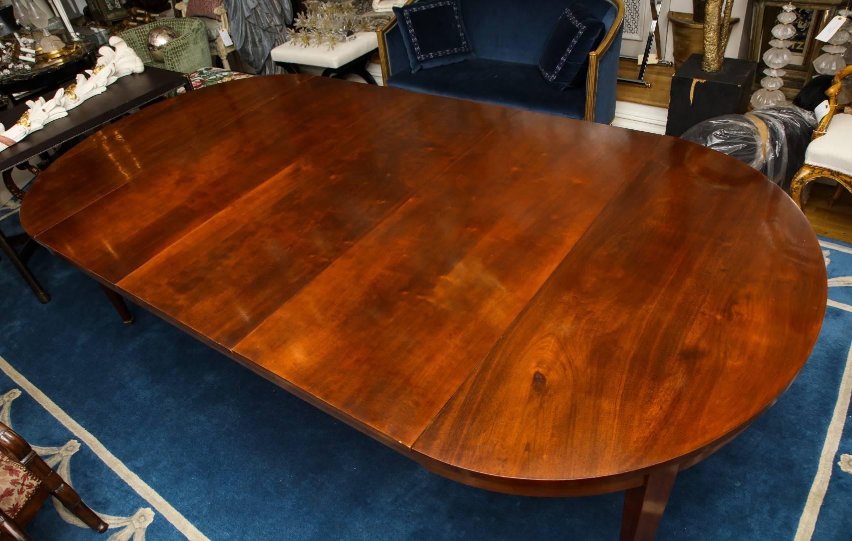 A mahogany extendable dining table, brass block foot, possibly French

Measure: 19.75" L per leaf. 

Diameter is 23.5 without leaves.