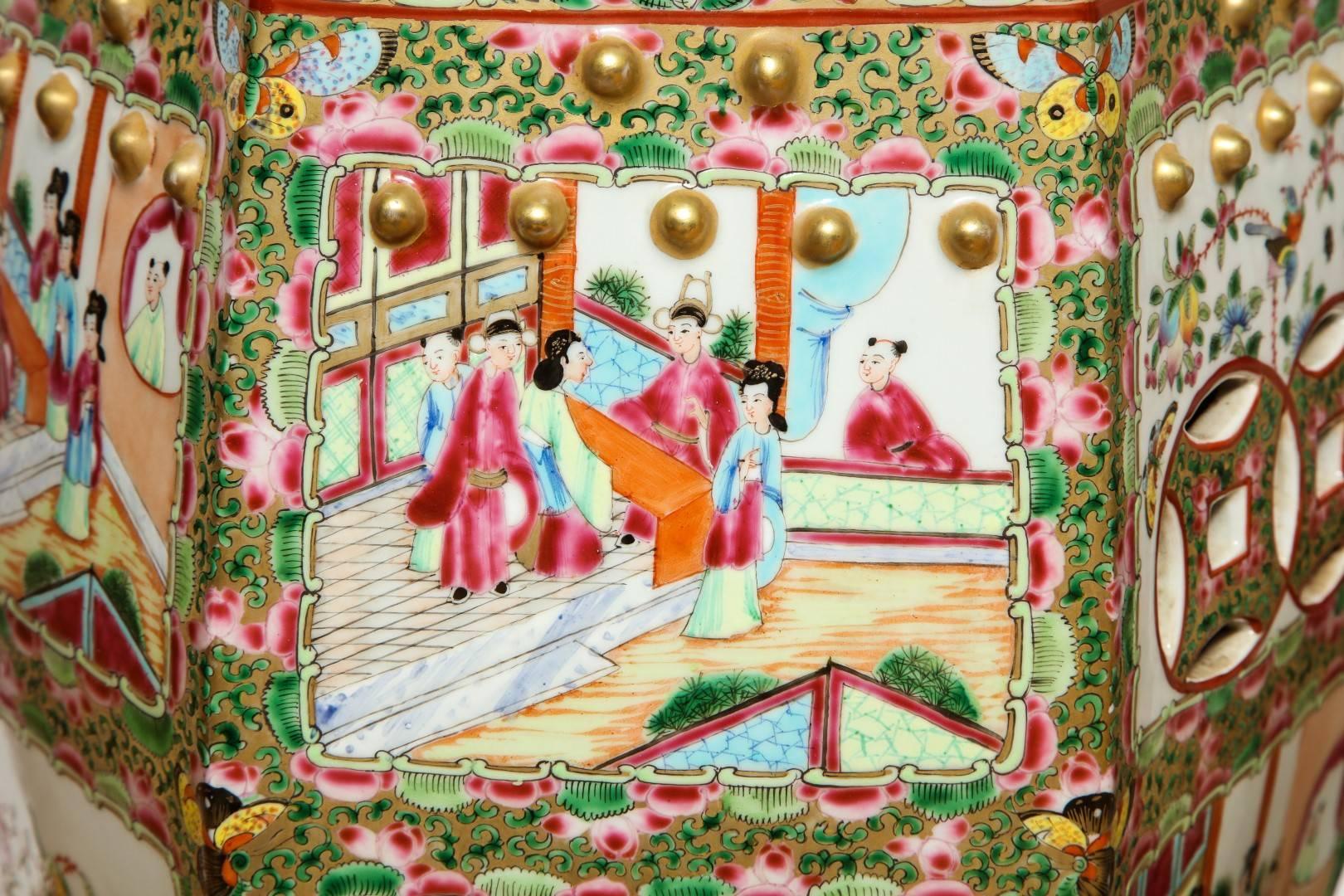 A pair of Chinese Famille decorated with cartouches depicting court scenes and panels with floral motif, painted throughout in pink, green, blue and gold enamel, late 19th century.