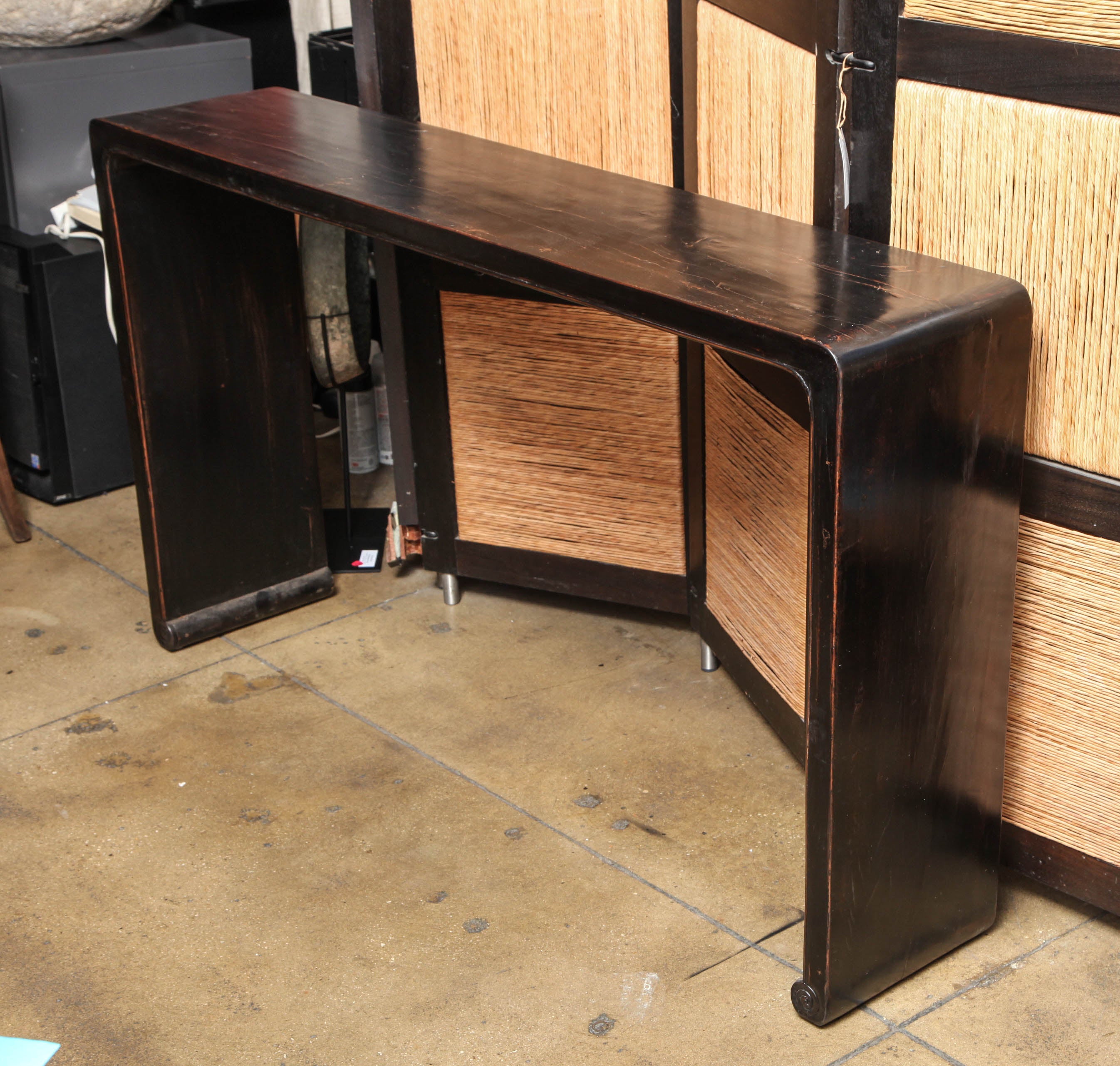 A black lacquered elm scroll table or console.