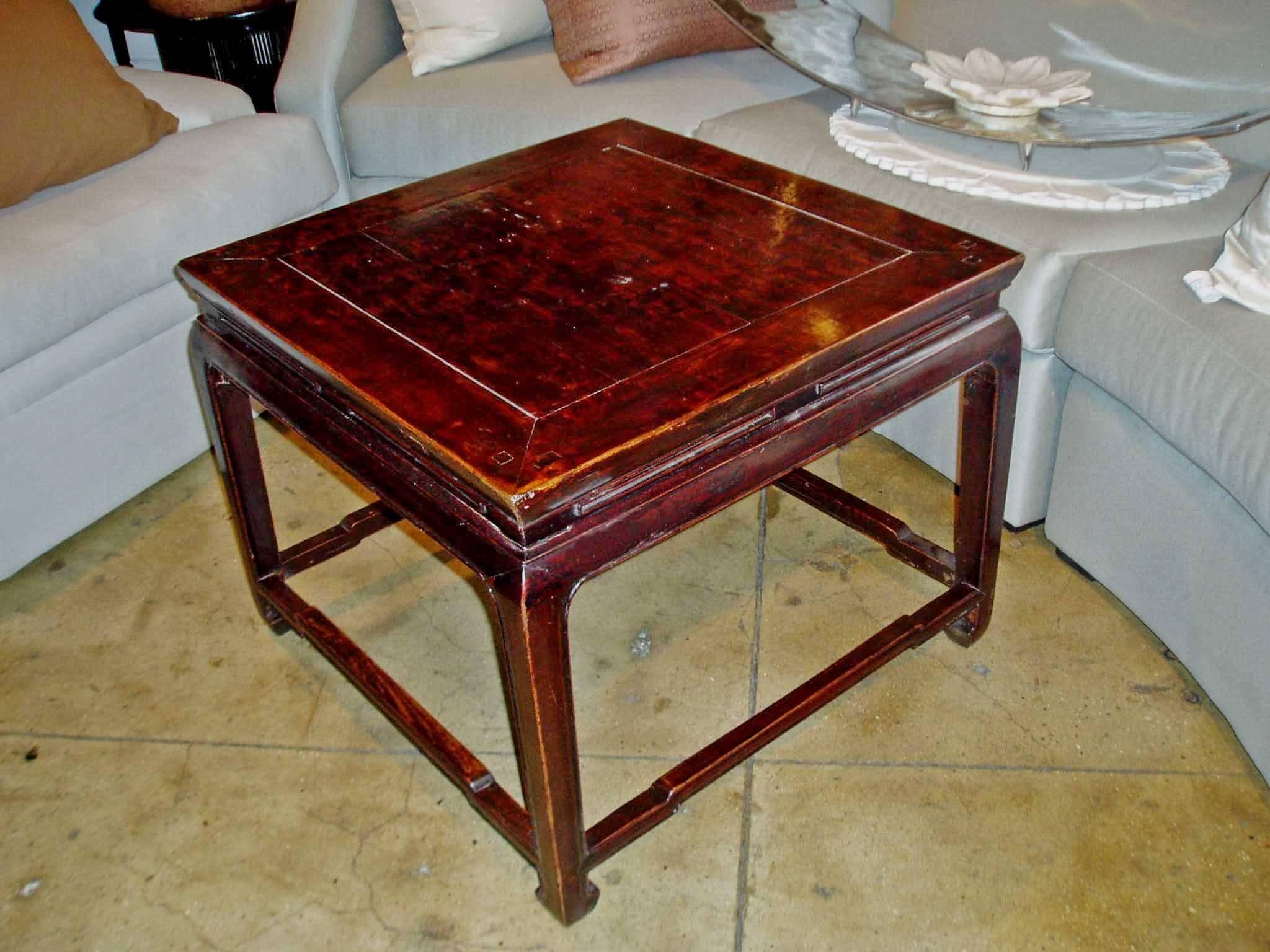 A square coffee table from China, with slotted apron, corner legs and hump back stretchers, circa 1925. 