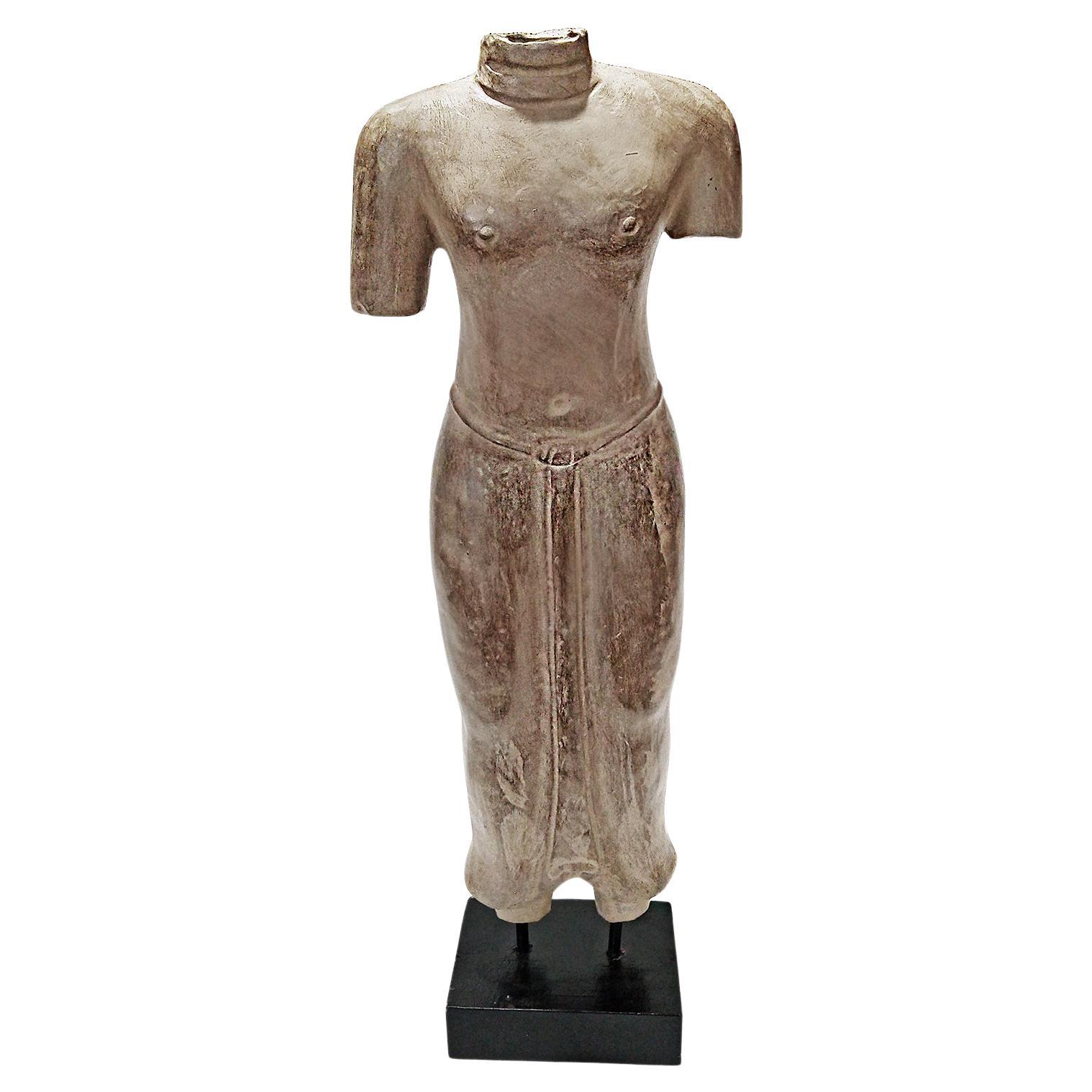 A table-top sculpture of a torso in traditional attire, hand carved from a single piece of sandstone. From Thailand. Contemporary.

Mounted on a wood / metal stand. 29.5 inches high, 10 inches wide, on a 5