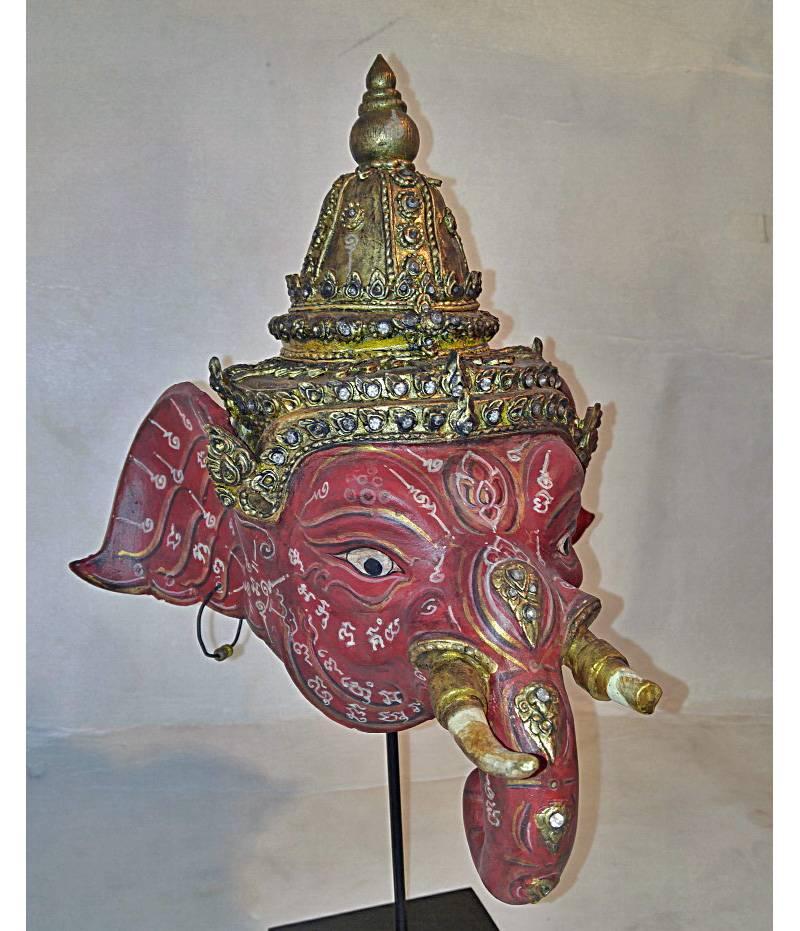 A small Khon dance drama mask of Ganesha, a Hindu deity, patron of the arts, remover of obstacles and the deva of wisdom, small, on stand. Dimensions: 9 3/4"W x 9"D x 15"H.