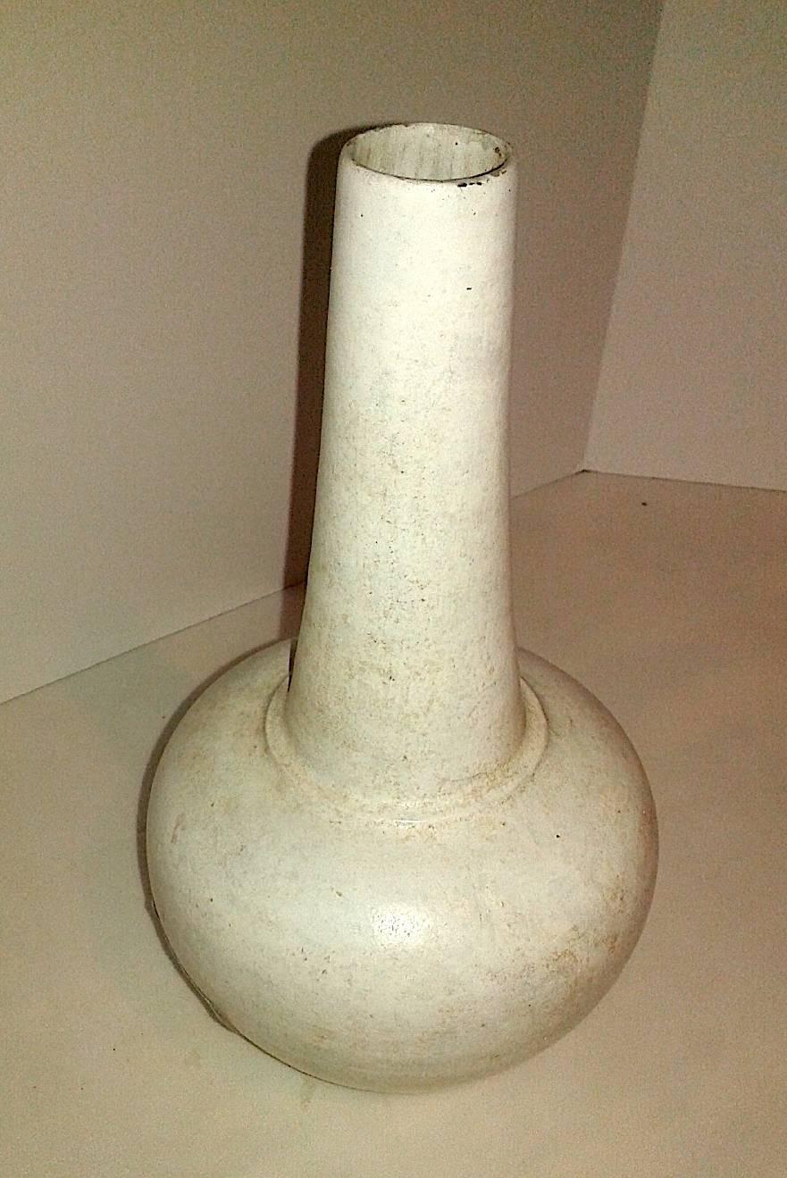 A ceramic vase with opaque white glaze, from Thailand. Fluted long neck with narrow mouth. From Thailand.