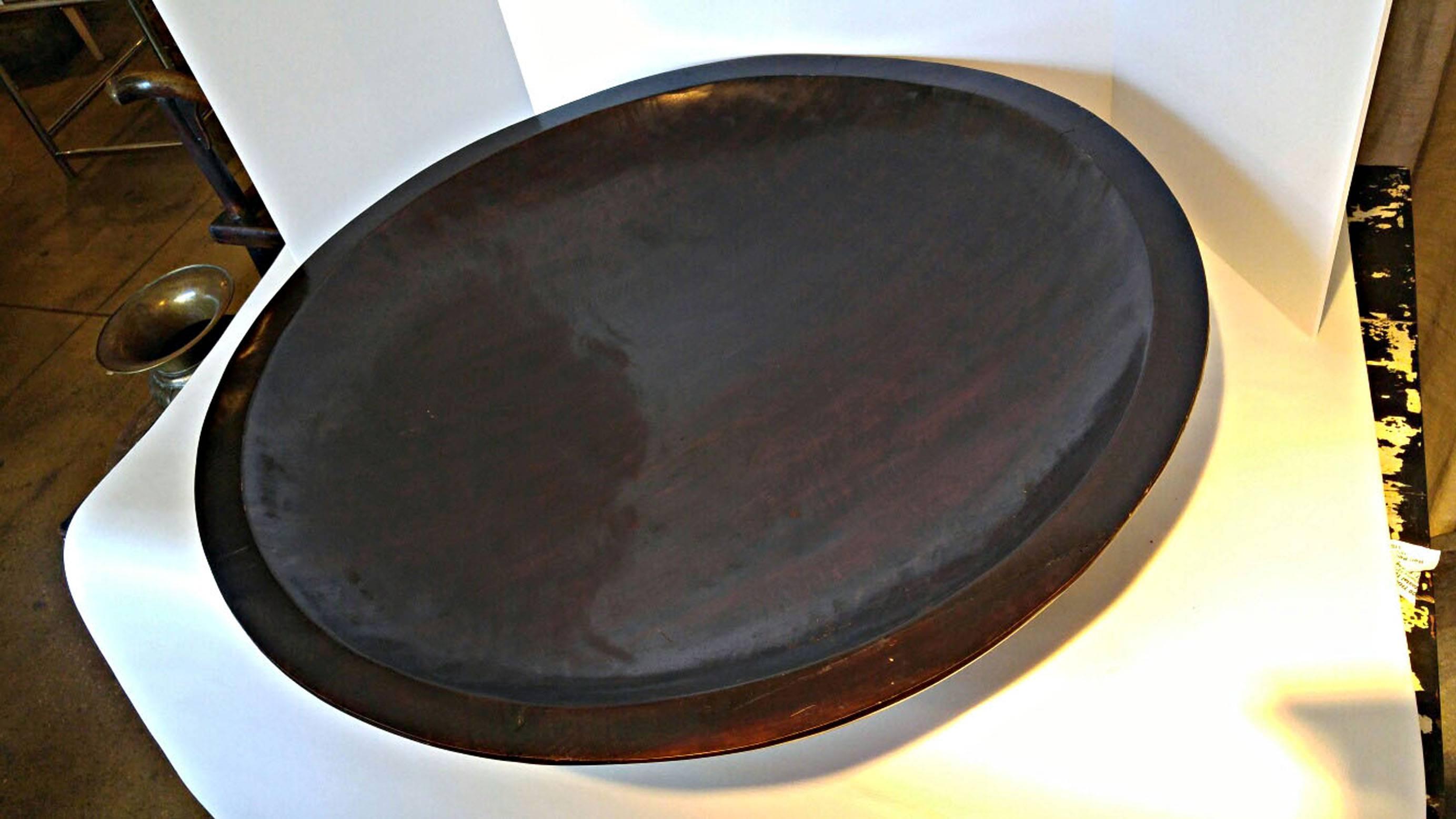 A large lacquered mahogany server, bowl, or centrepiece in a dark finish from Indonesia.