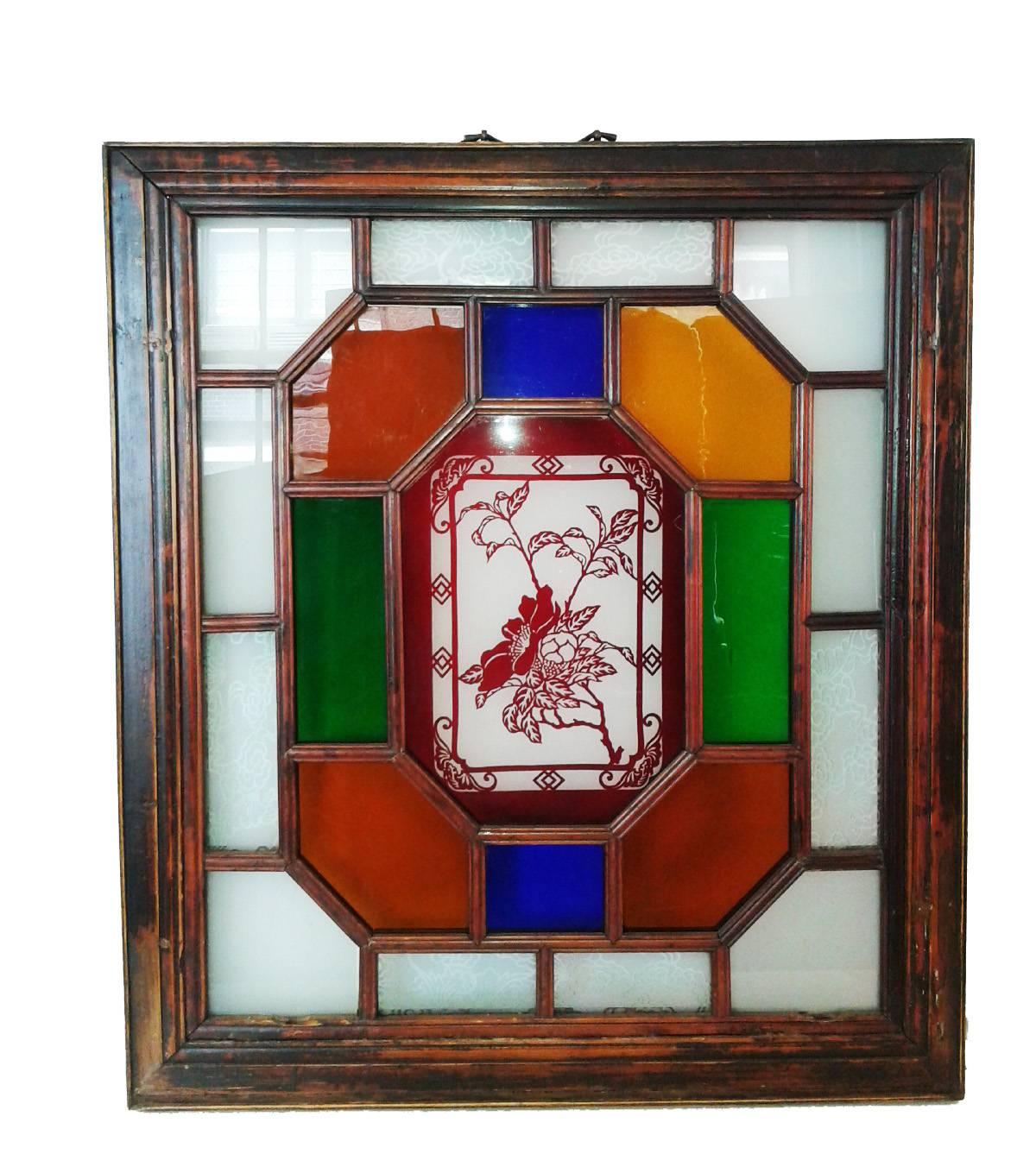 A Manchurian stained-glass panel on a wood frame, Late 19th century. Floral motif in the center, plus etching on clear panels. Excellent antique condition. Slight wear commensurate with age and use. Special price.