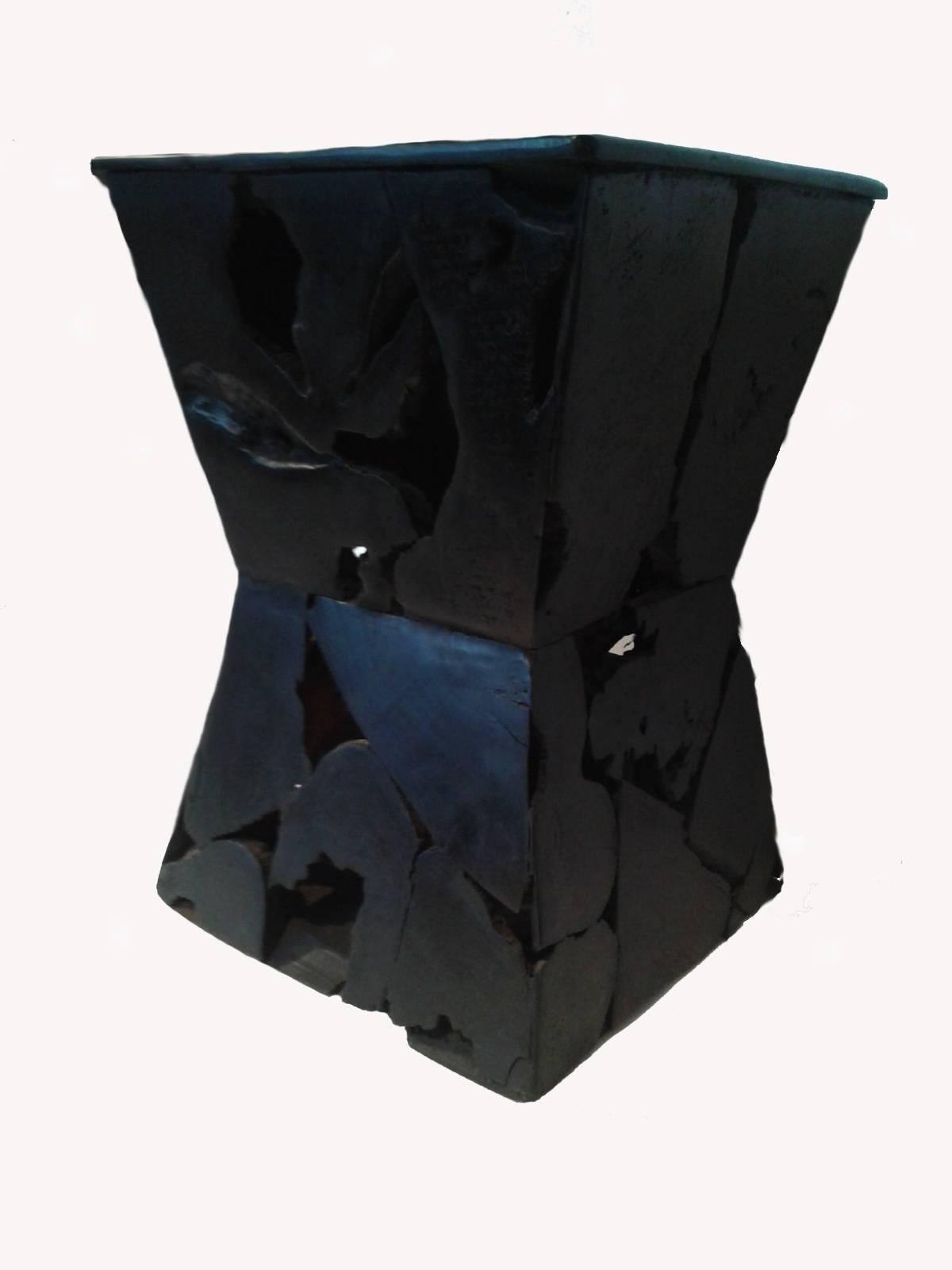 An hourglass shaped end table, carved out of strong black wood, from Indonesia. With its singular mosaic pattern, this original table is the perfect accent for modern, eclectic decor. Solid construction, polished top. Excellent vintage condition.