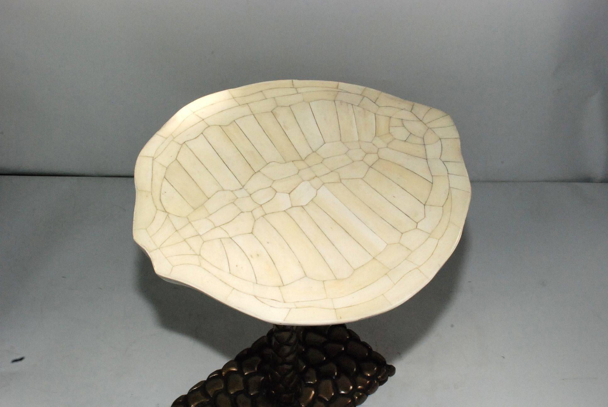 Sculptural bone turtle shell design top with brass base end table and white lacquered finish.