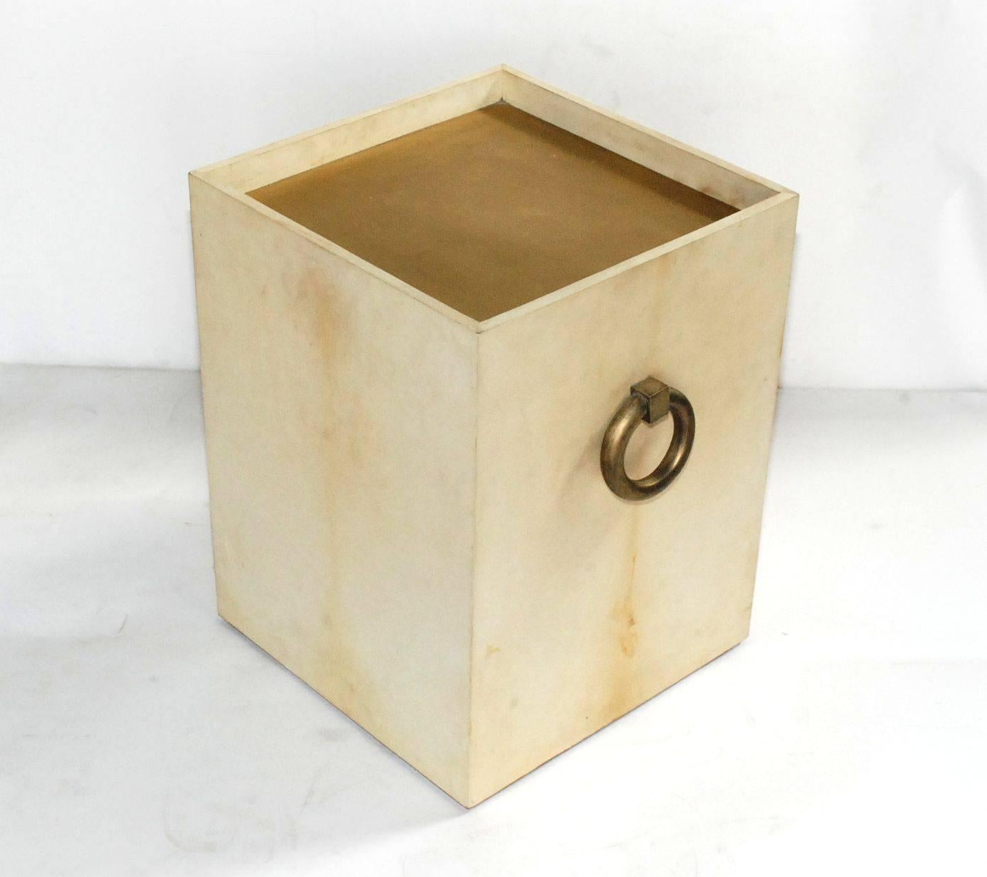 Elegant single natural parchment end table with brass ring handles.