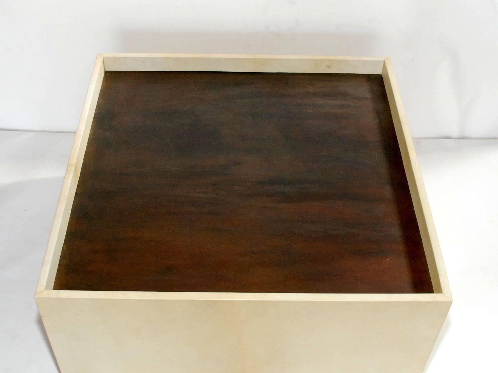 Elegant coffee table cover with natural parchment with brass ring handles.