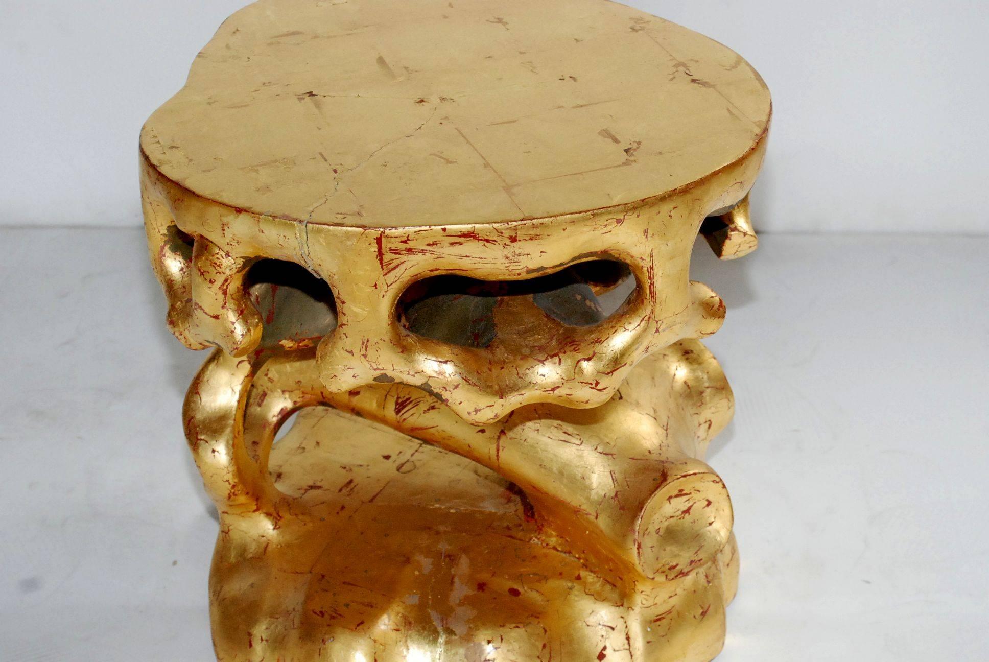 Pair of resin side tables cover with gold leaf.