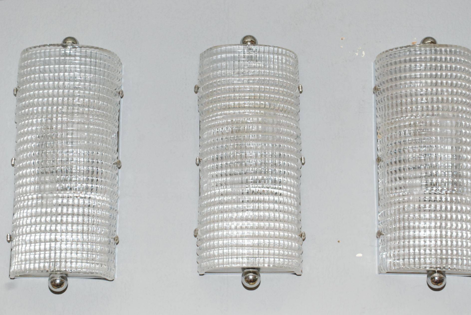 1960s set of eight clear bauletto shield sconces by Mazzega.
Sconce has two-light each and frame chrome-plated.