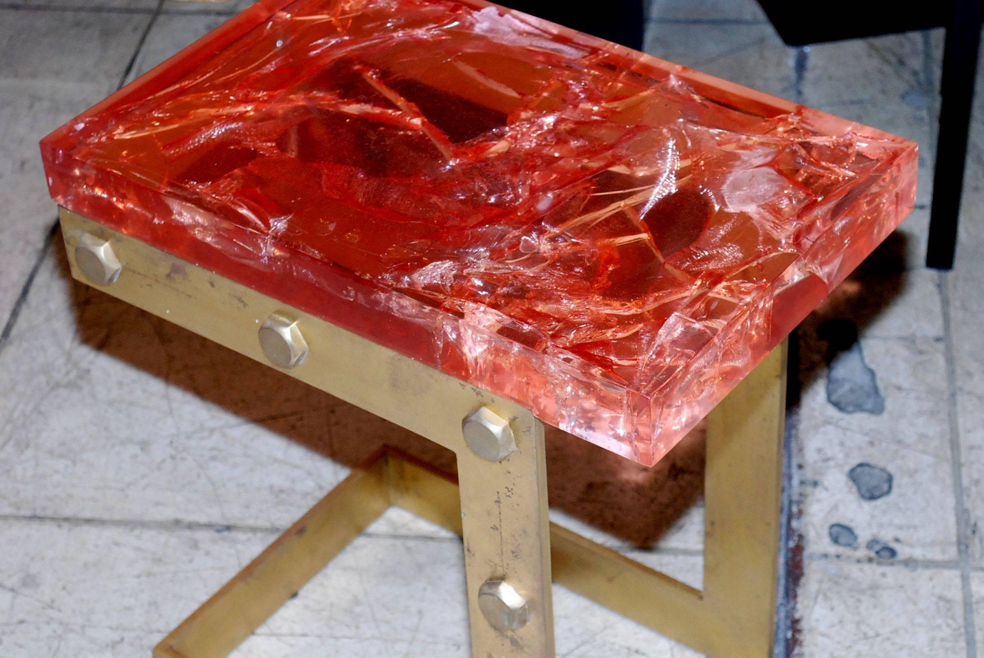 Solid iron with antique gold finish base side table with thick red crackle resin top.