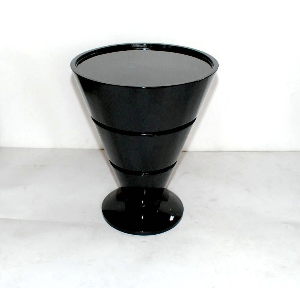 Elegant pair of black lacquered barrel style side tables.