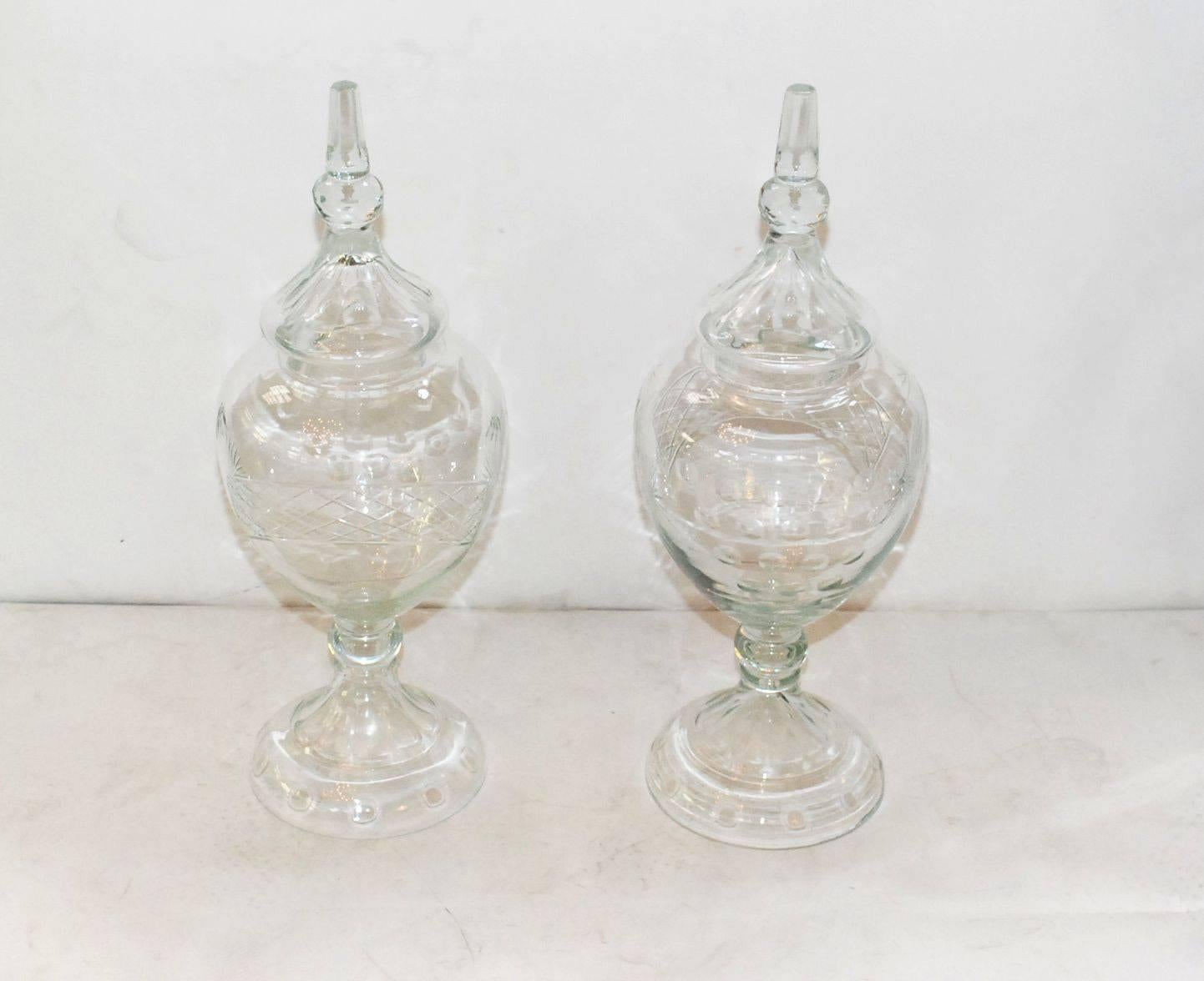 A pair of 19th century French apothecary cut-glass jars with faceted finials. Please note: There is minor chips top cover see details pictures overall great vintage condition.