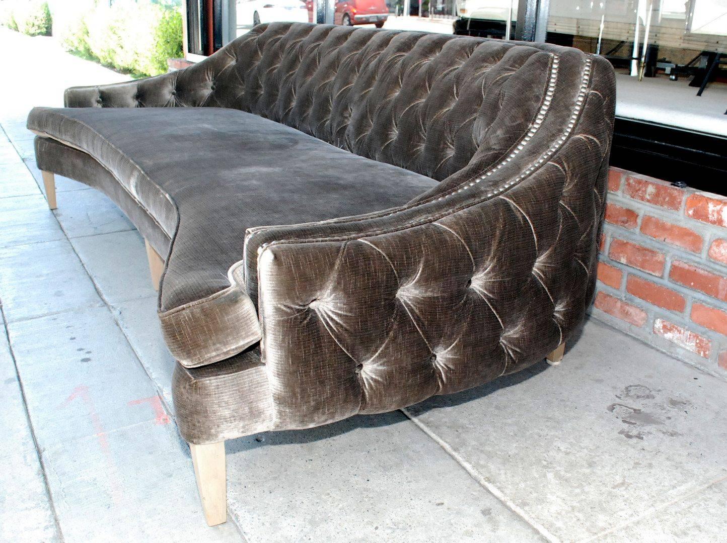 A great Hollywood Regency style upholstered with dark grey velvet. Curved tufted back and front and light ceruse finish on legs.