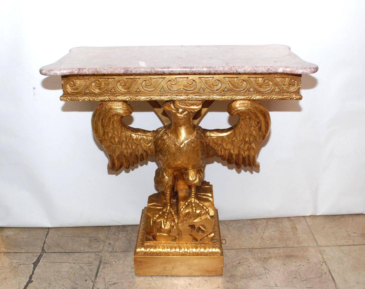 Eagle console table with pink and white marble top.