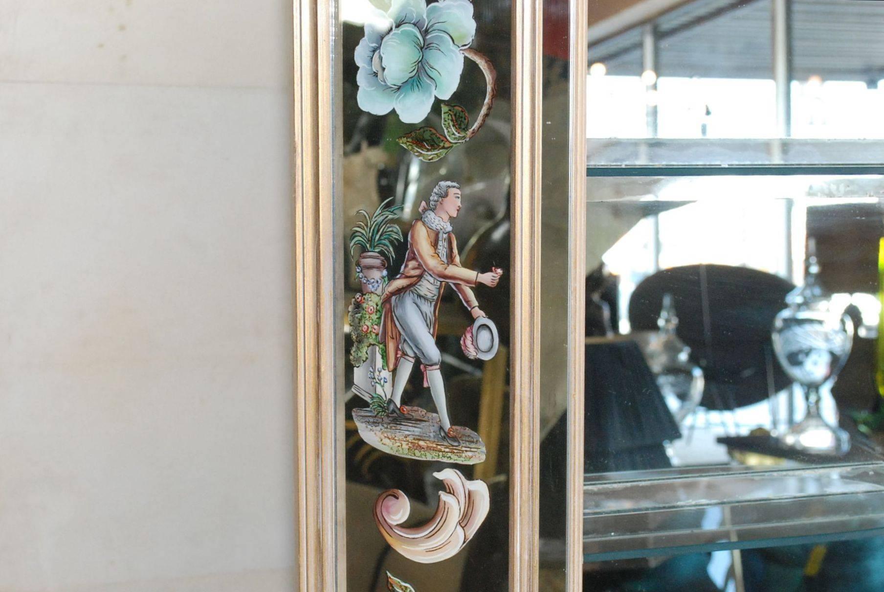 1960s Hollywood Regency style wall mirror with four shelves. Elegant design of figurines and flowers reverse paint also few lights.