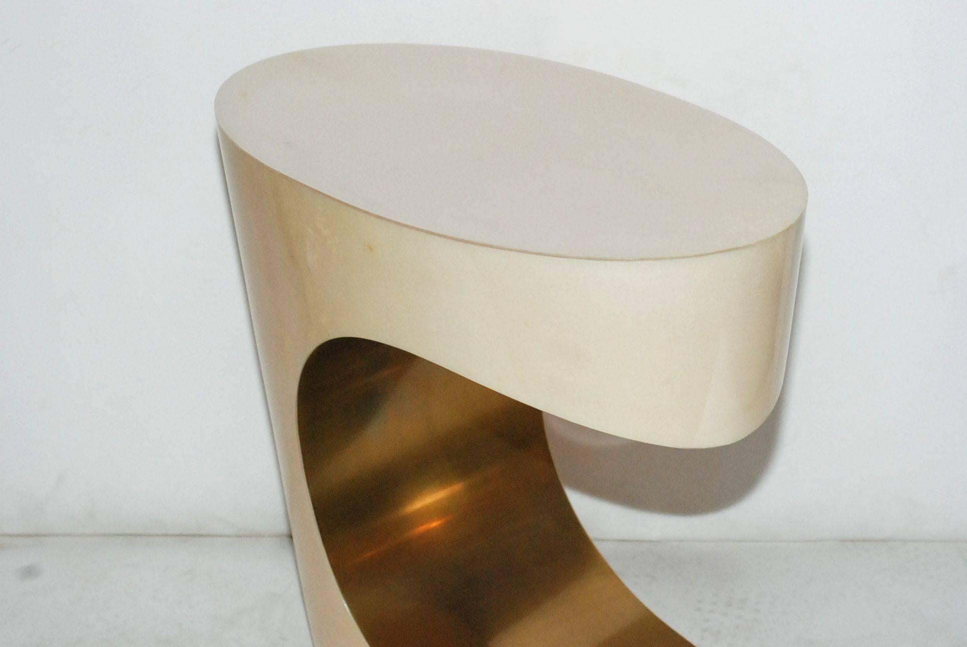 Pair of sculptural sofa tables cover with goatskin and brass. Parchment is in varying shades of natural. (High gloss polyester resin filled finish).