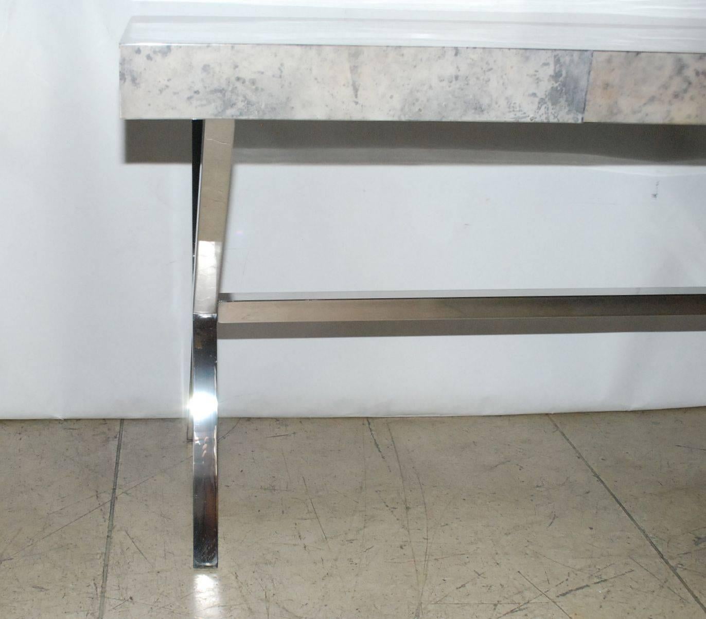 Elegant console table cover with goatskin and chrome X-design base. Parchment is in varying shades of light grey. (High gloss polyester resin filled finish).