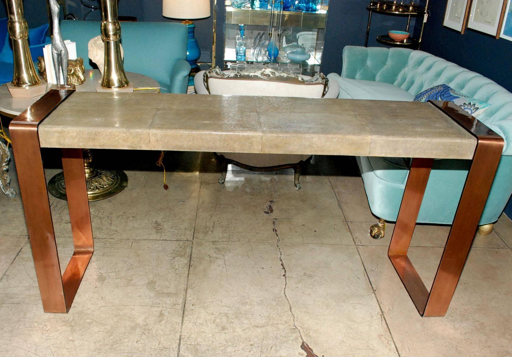 Large sculptural console table cover with shagreen with copper on iron finish legs.