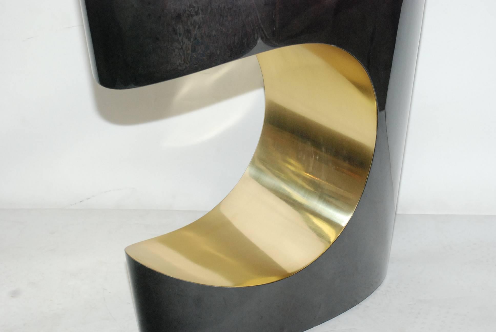 Pair of sculptural sofa tables cover with goatskin and brass. Parchment is in varying shades of charcoal. (High gloss polyester resin filled finish).