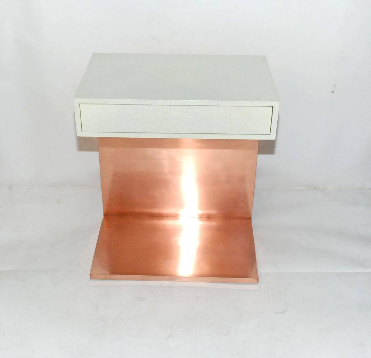 Pair of elegant large side tables or nightstands cover front and back with white shagreen and copper finish on solid brass. Each table has single drawer.