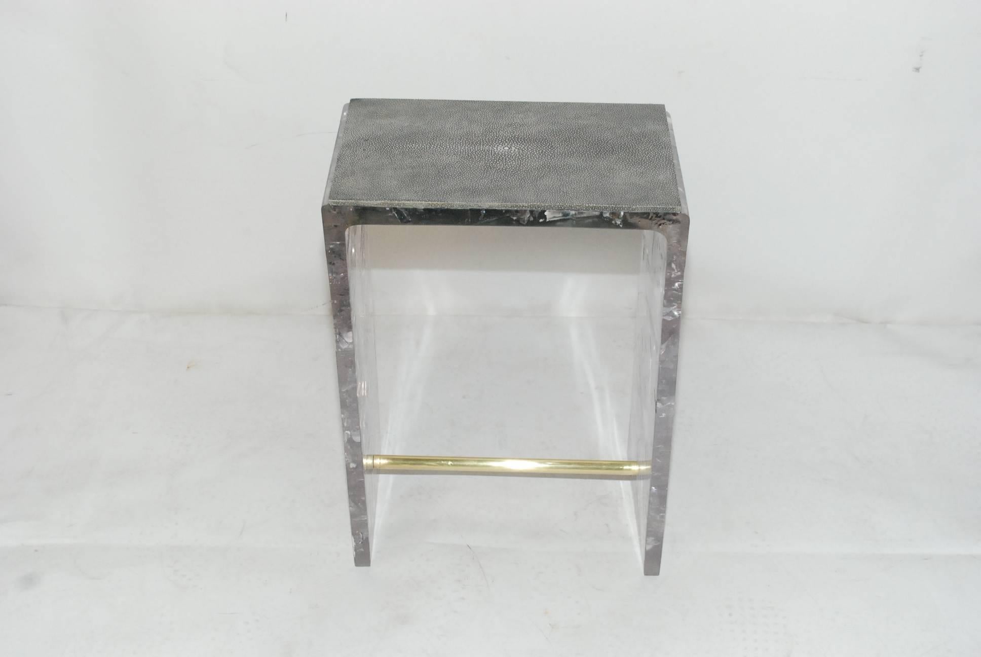 Elegant crackle resin end tables cover with shagreen and brass detail.