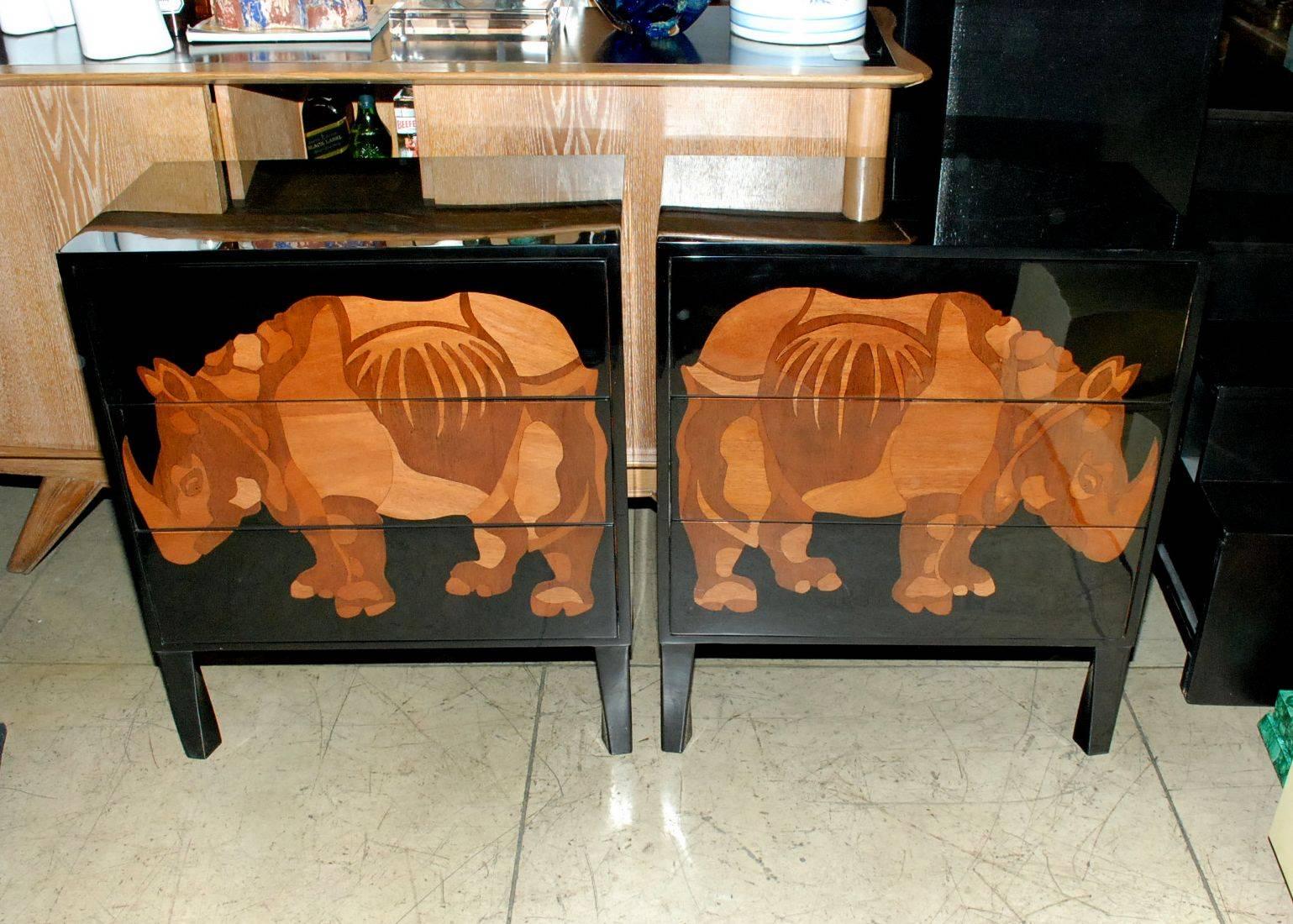 A great pair of black lacquered commodes with wood inlay rhino design (right and left). Each chest has three drawers.
