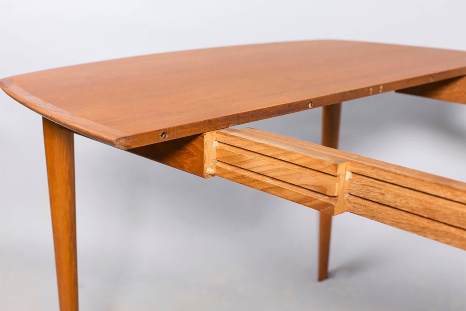 Vintage 1960s square teak dining table.

Square teak dining table with bowed sides. Three additional leaves that are inches 22