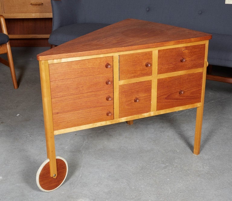 Vintage 1950s Danish Side Table or Sewing Table

This awesome piece features drawers that open from both sides, a functioning teak wheel and handles that make it a wheel barrow. It also has an spool extension for spinning yarn and another