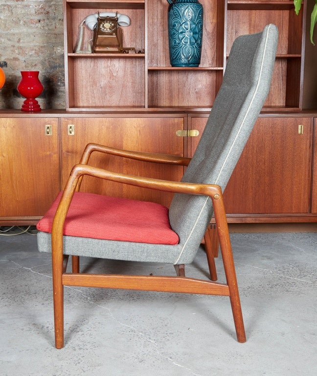 Vintage 1950s Kurt Olsen Teak Armchair

This hair with grey and red upholstery. The frame design is open and light, allowing this nicely proportioned chair to fit in most environments. The body of the chair is covered in a grey wool/cotton blend