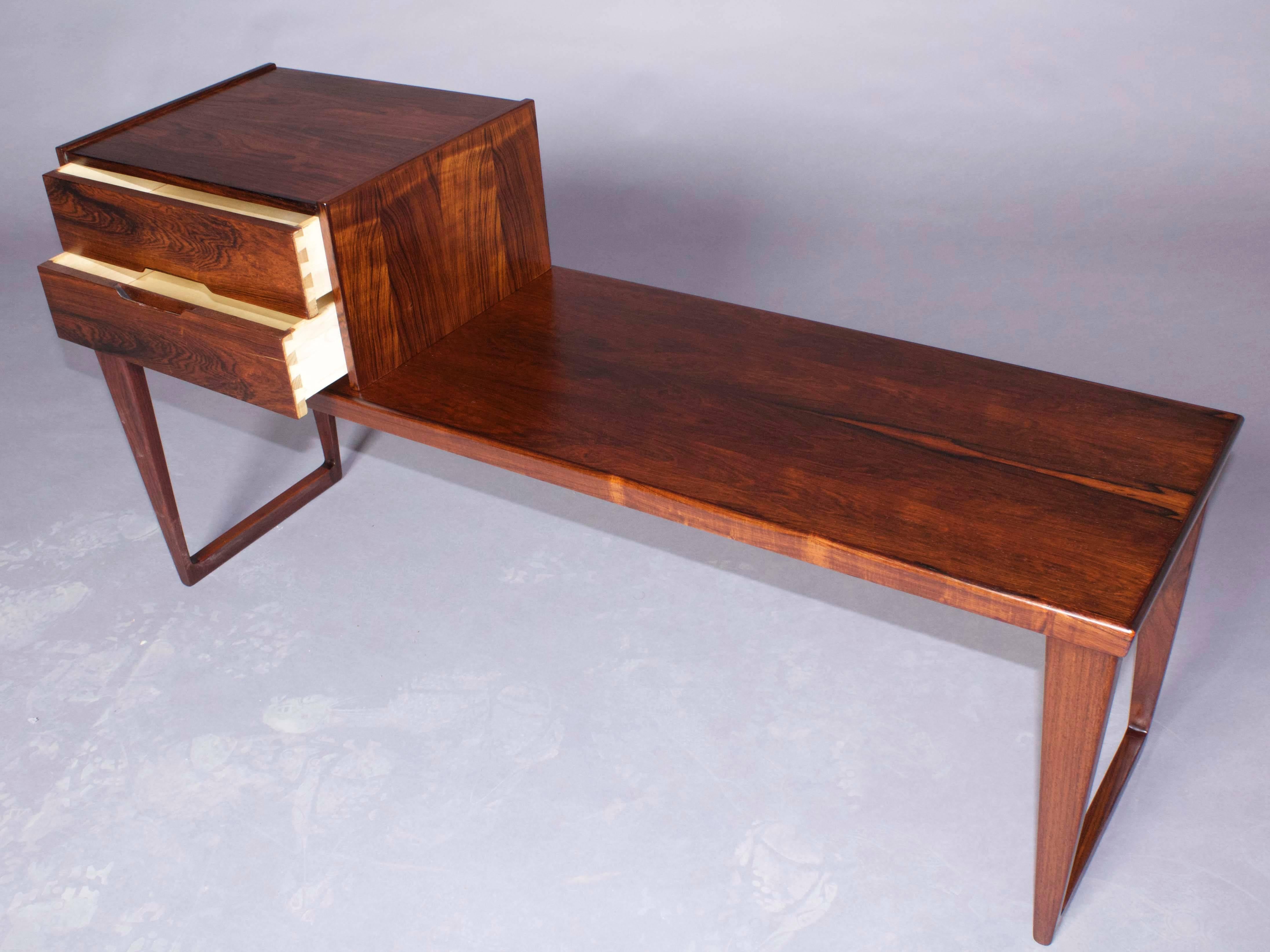 Vintage 1960s Bench by Aksel Kjersgaard.

Rosewood bench designed by Aksel Kjersgaard for Odder Furniture. The drawer unit that you see is removable and can be placed on the right side, middle or left side of the bench. This item will look perfect