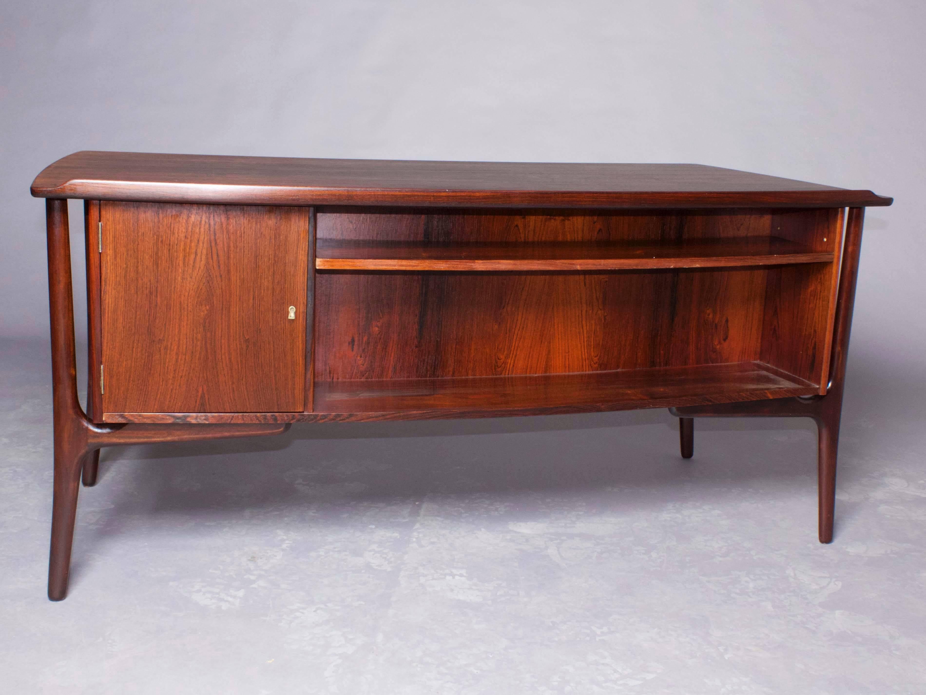 Vintage 1960s Svend Madsen Desk

Danish mid century modern 8 drawer executive desk by Svend Aage Madsen, produced by H.P. Hansen. Beautiful grain, back storage and locking cabinet highlight this superb desk. Blemish on upper right hand and lock on