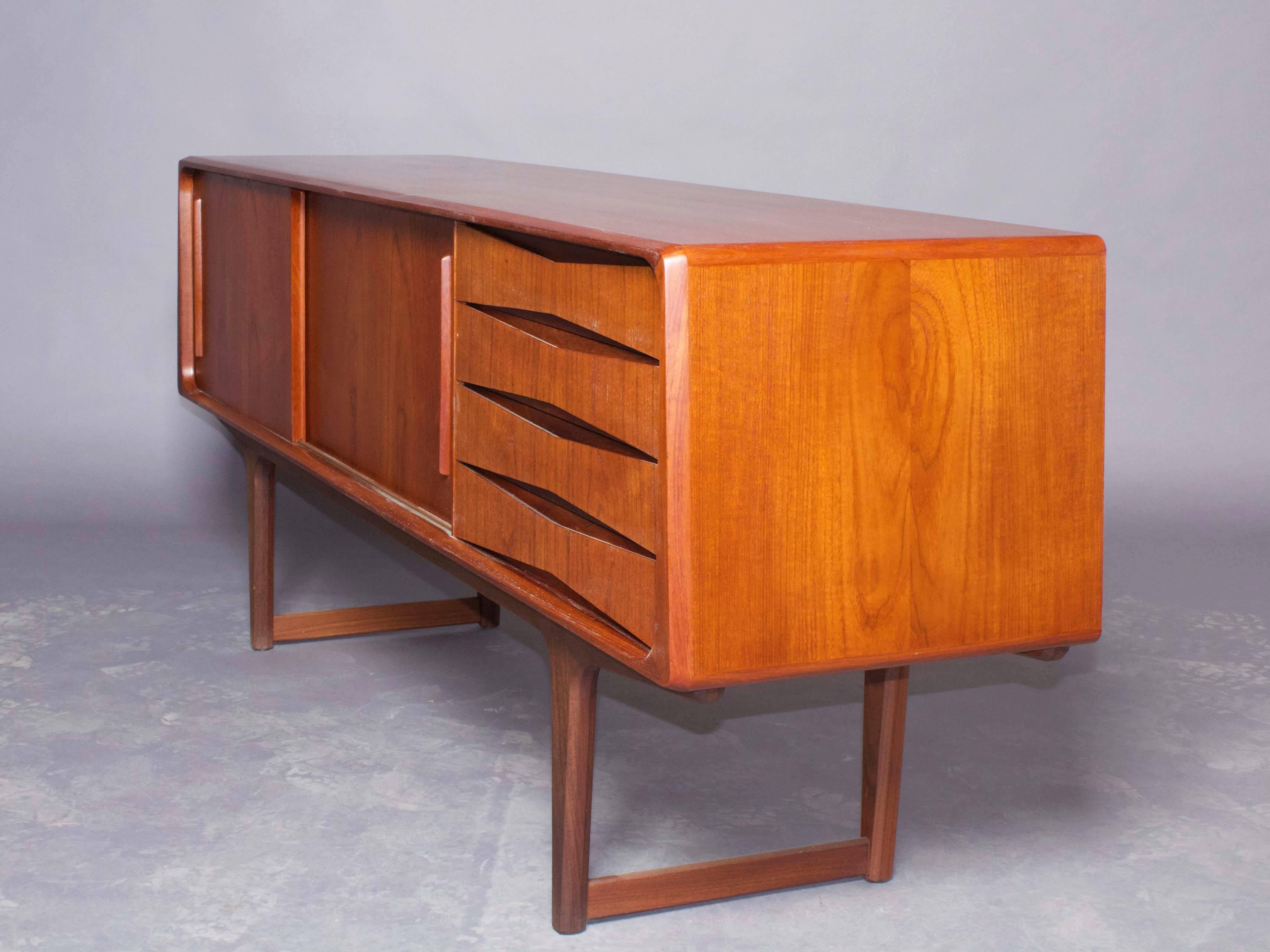 Vintage 1950s Danish Credenza 

This Danish sideboard is in like new condition and has an unusual trapezoidal shape. Four drawers, two sliding doors with adjustable shelves. Ready for pick up, delivery, or shipping.