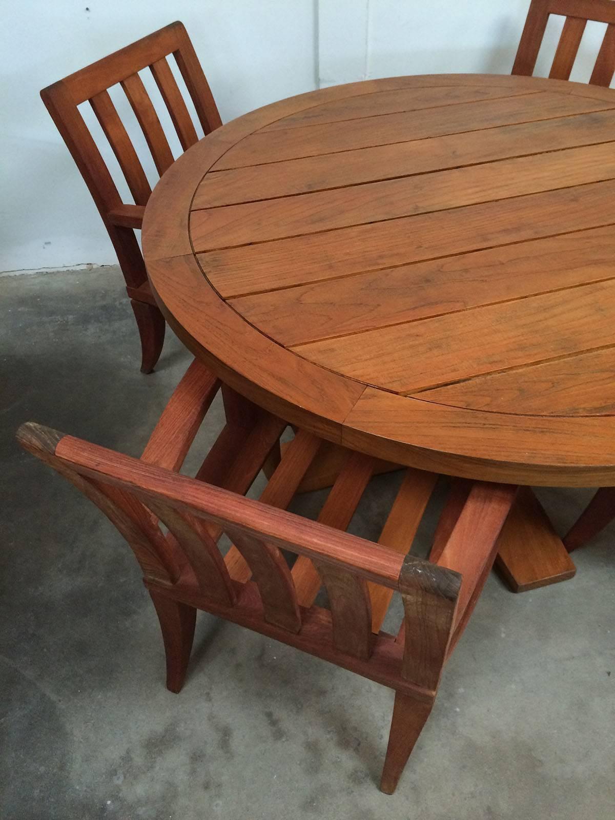 Large round outdoor table and four chairs in solid teak.
 The table is 58 wide X 29 high and chairs are listed below.