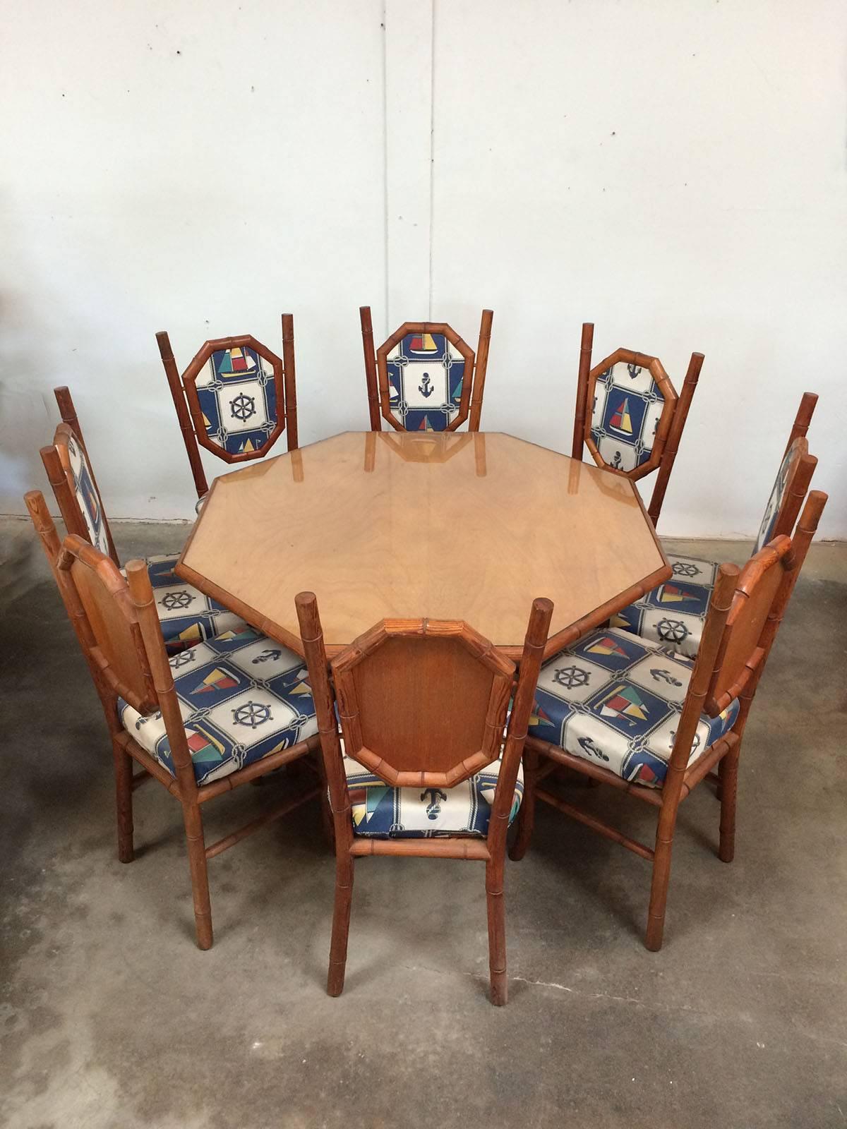 Card table and six chairs in red wood and nautically themed fabric. Wood has been turned to imitate bamboo and the octagonal table is surfaced in laminated plywood and then glass for protection.
