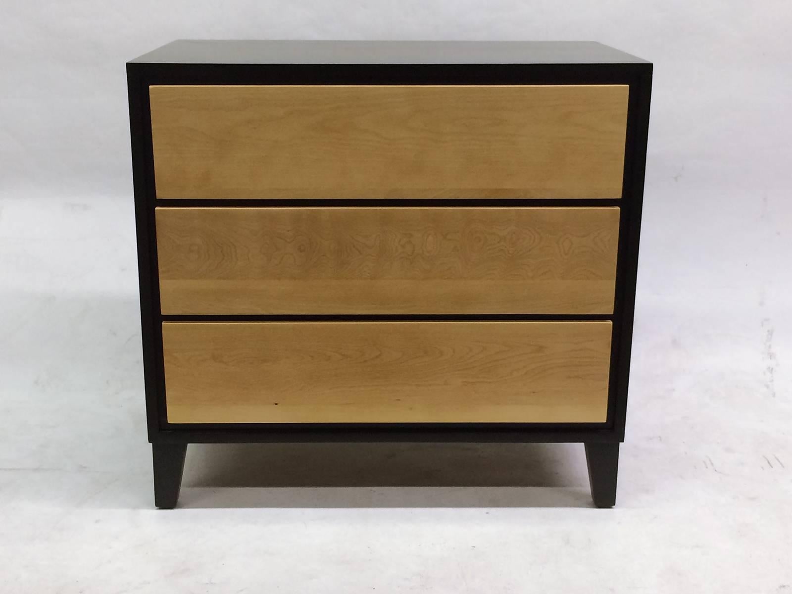 These vintage 1950s designed chests of drawers or nightstands by Russel Wright for Conant Ball each feature three drawers made of solid maple and finished in natural and ebony finish. Russell Wright was an American industrial designer working during