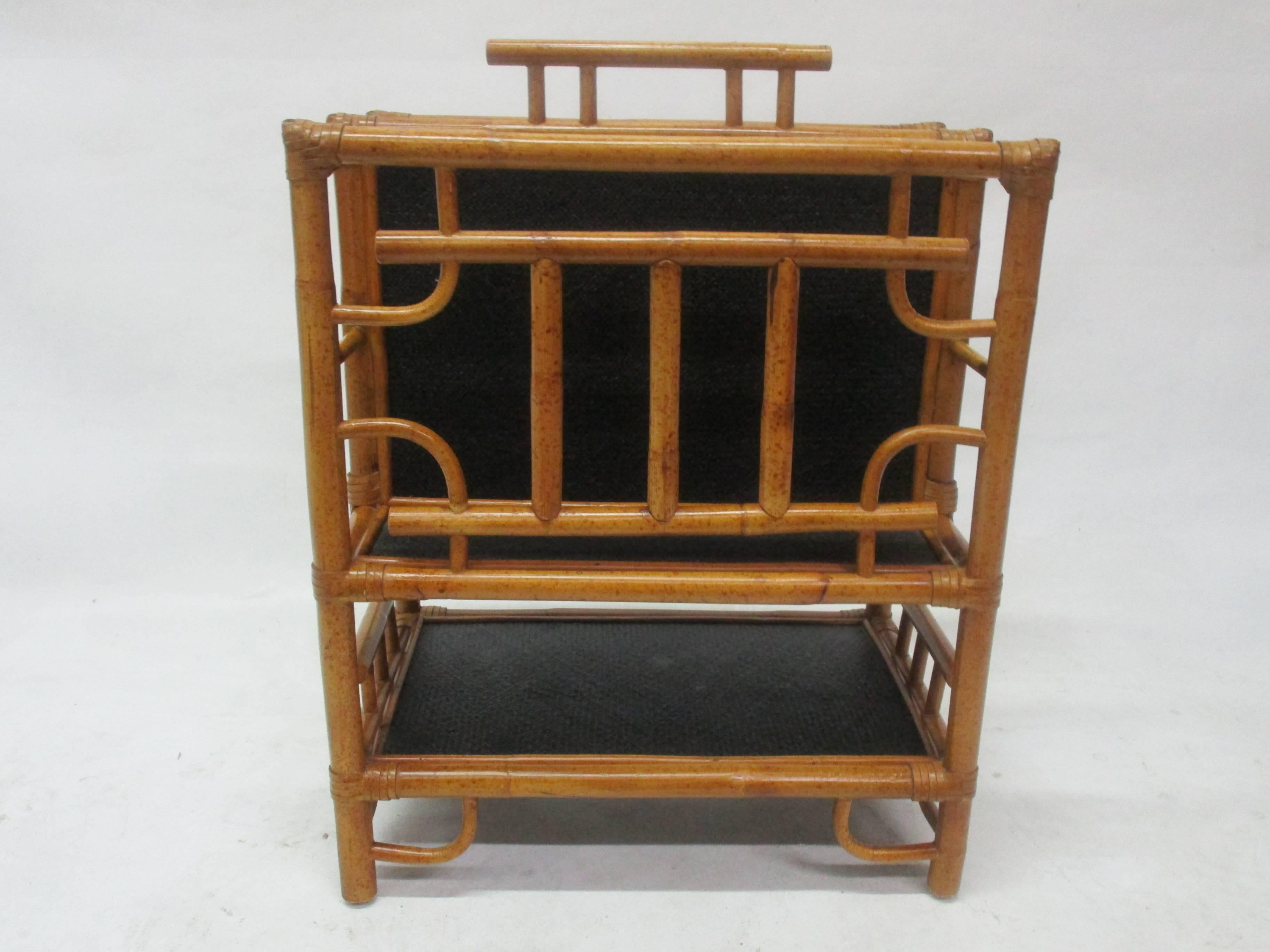 Large magazine rack made of bamboo and black stained rattan. The height has been measured without the handle which adds 2.25