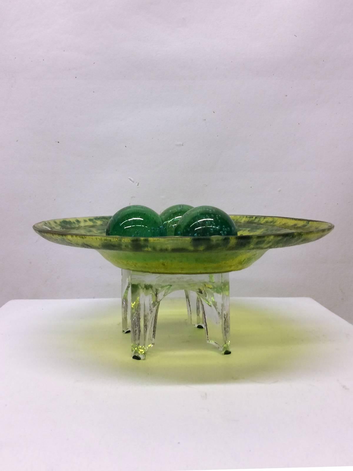 Blown glass bowl and balls on a glass stand. Listing includes five total pieces - three balls, one bowl and one stand. Balls are a grass green color, measure 11" around. Bowl is more of a yellow-green and is 17" in diameter, while the