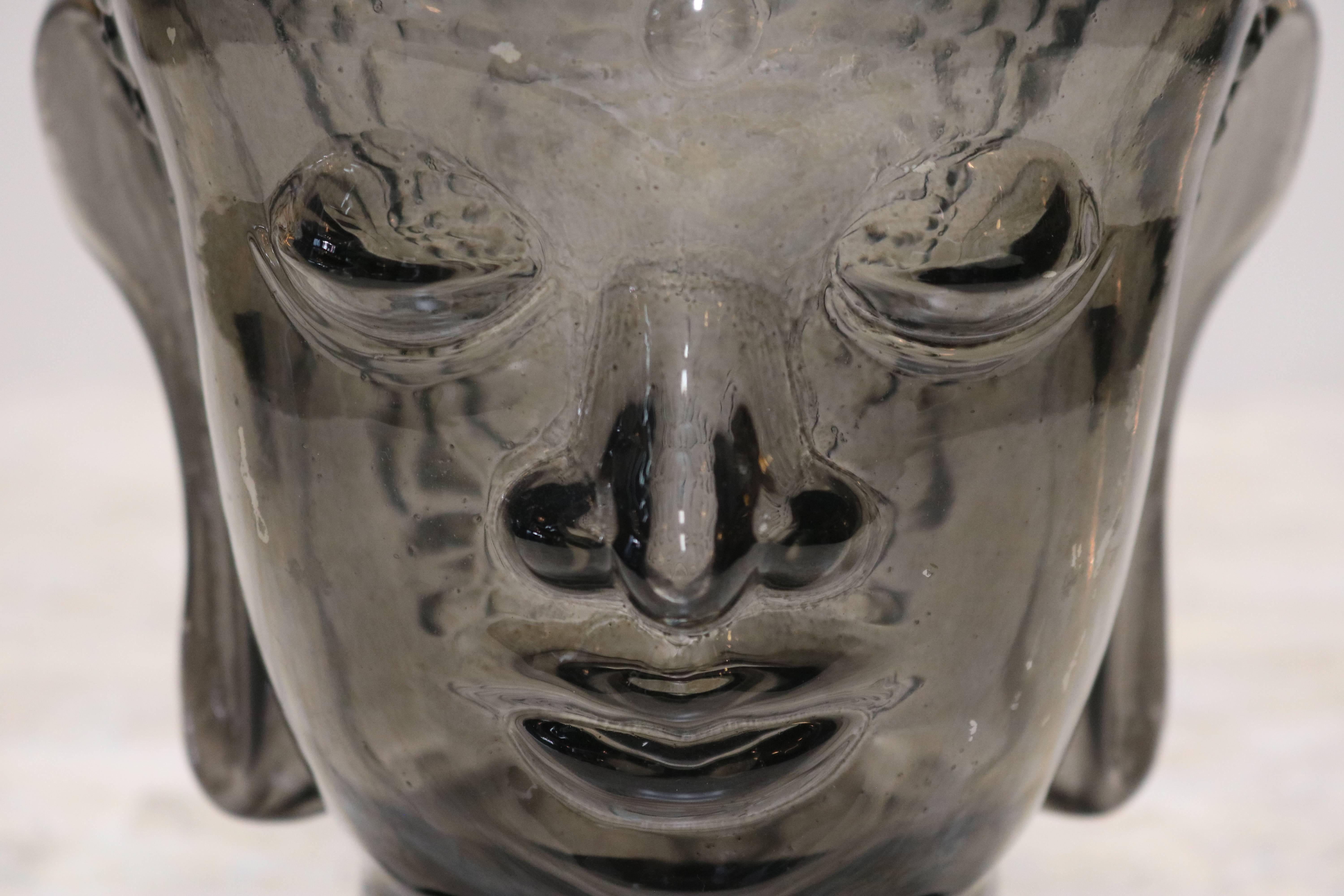 Smoked glass Buddha head decorative piece is hollow and has a black base.
Measures: Bottom base is 4.0