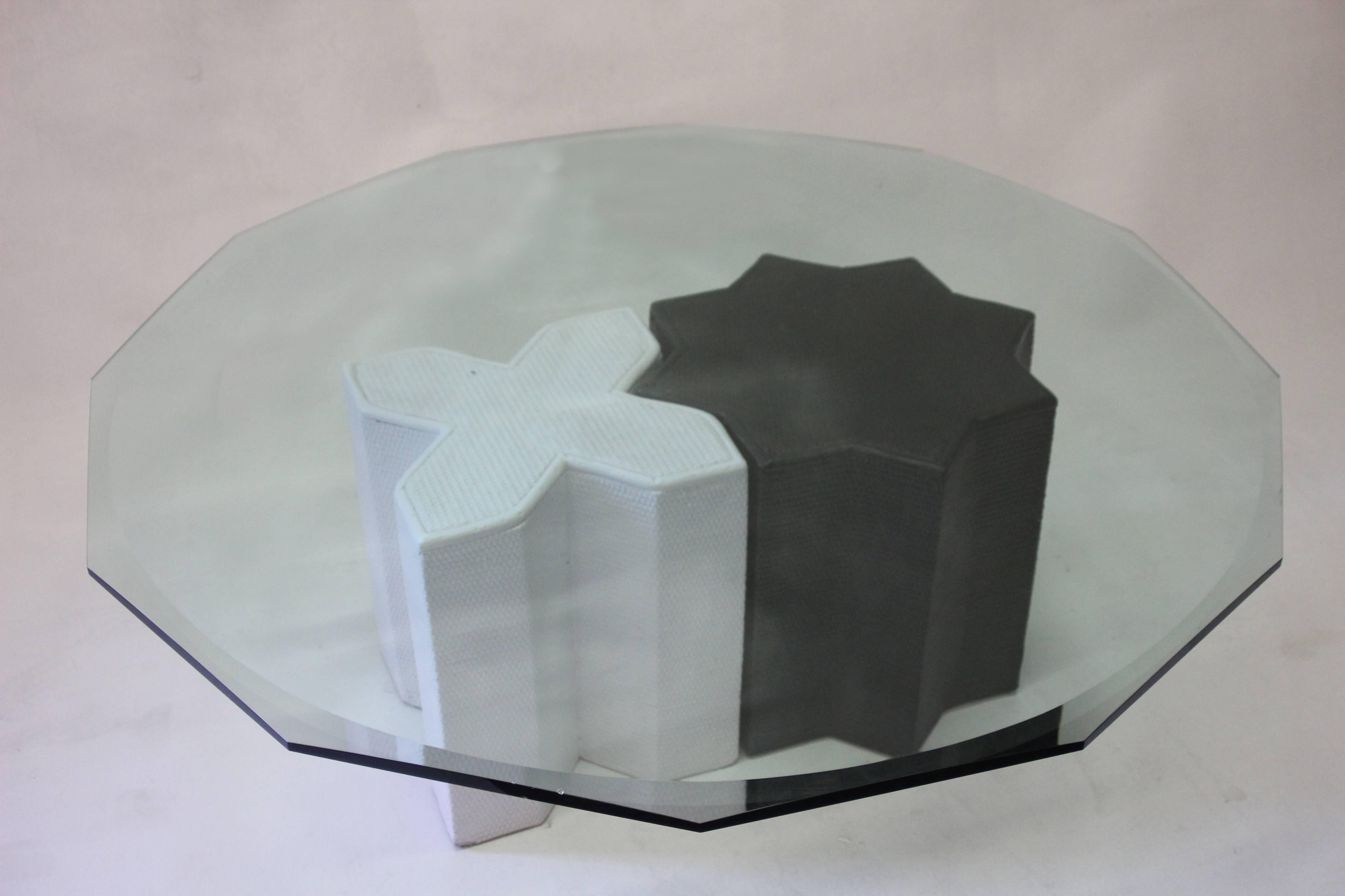 Beveled glass top coffee table has geometrically shaped edges. Base consists of two pieces that perfectly fit together or can be spaced apart as well as used as bases for side tables or small pedestals. Base parts newly repainted. Glass in very good