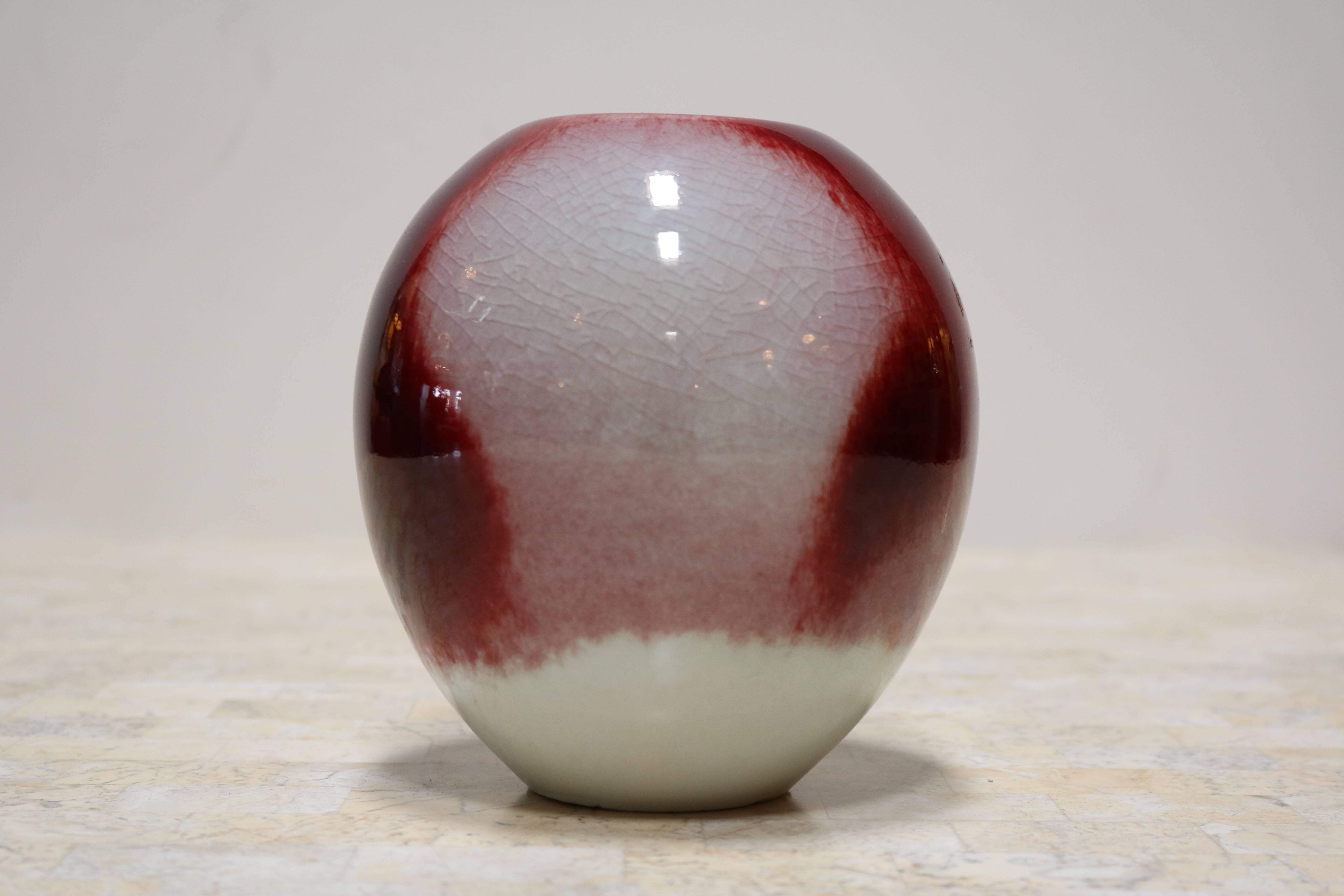 Candy apple red and cream decorative ceramic by Masuo Ojima. Top is recessed and has a small hole not usable as a vessel as it would not be possible to clean, but may have been intended as a stick incense holder and makes for a striking decorative
