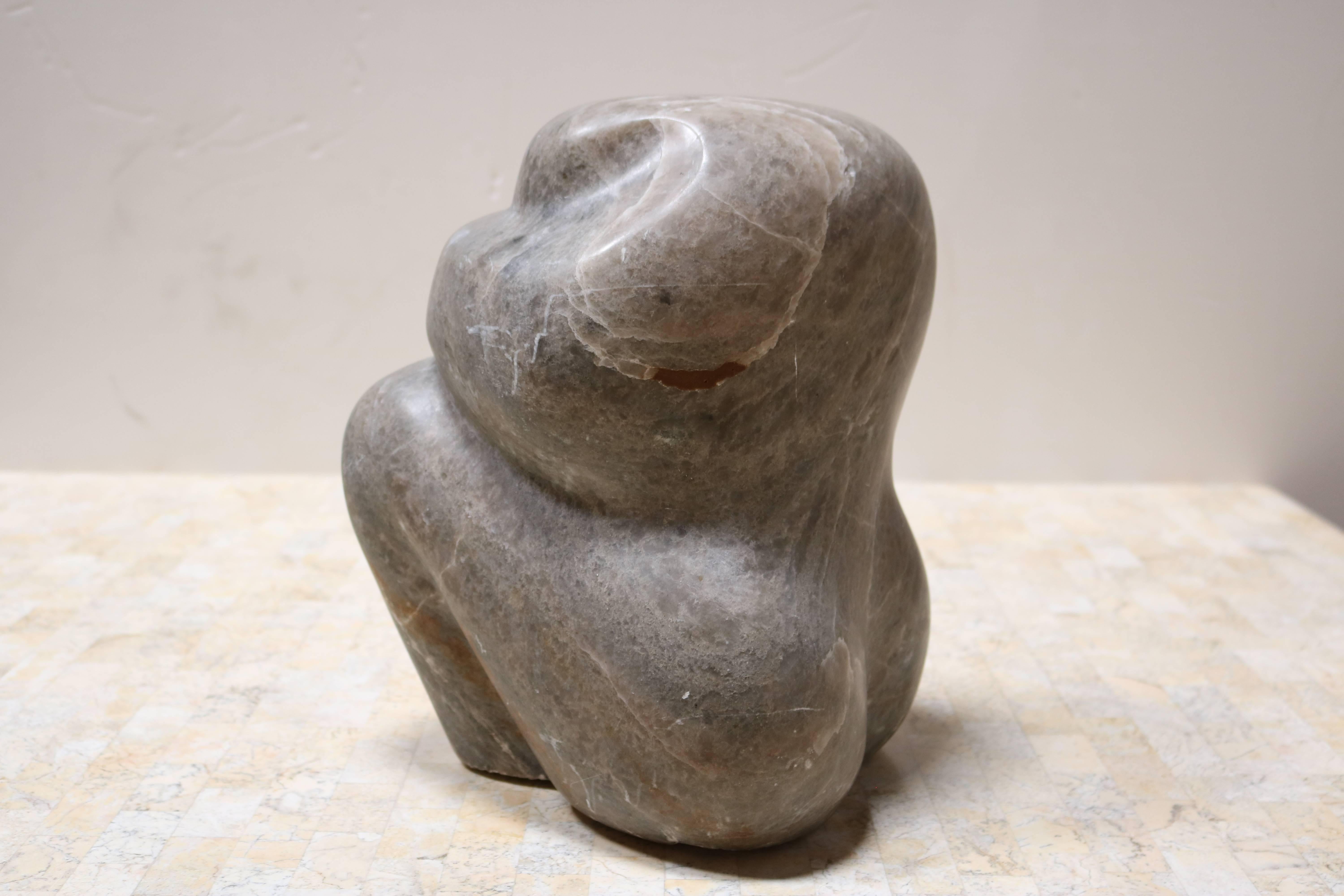 Evocative grey marble sculpture resembles a seated figure with bent leg resting it's head on folded arms.
It's carved in a beautiful chunk of marble.

Measures approximately 10.0