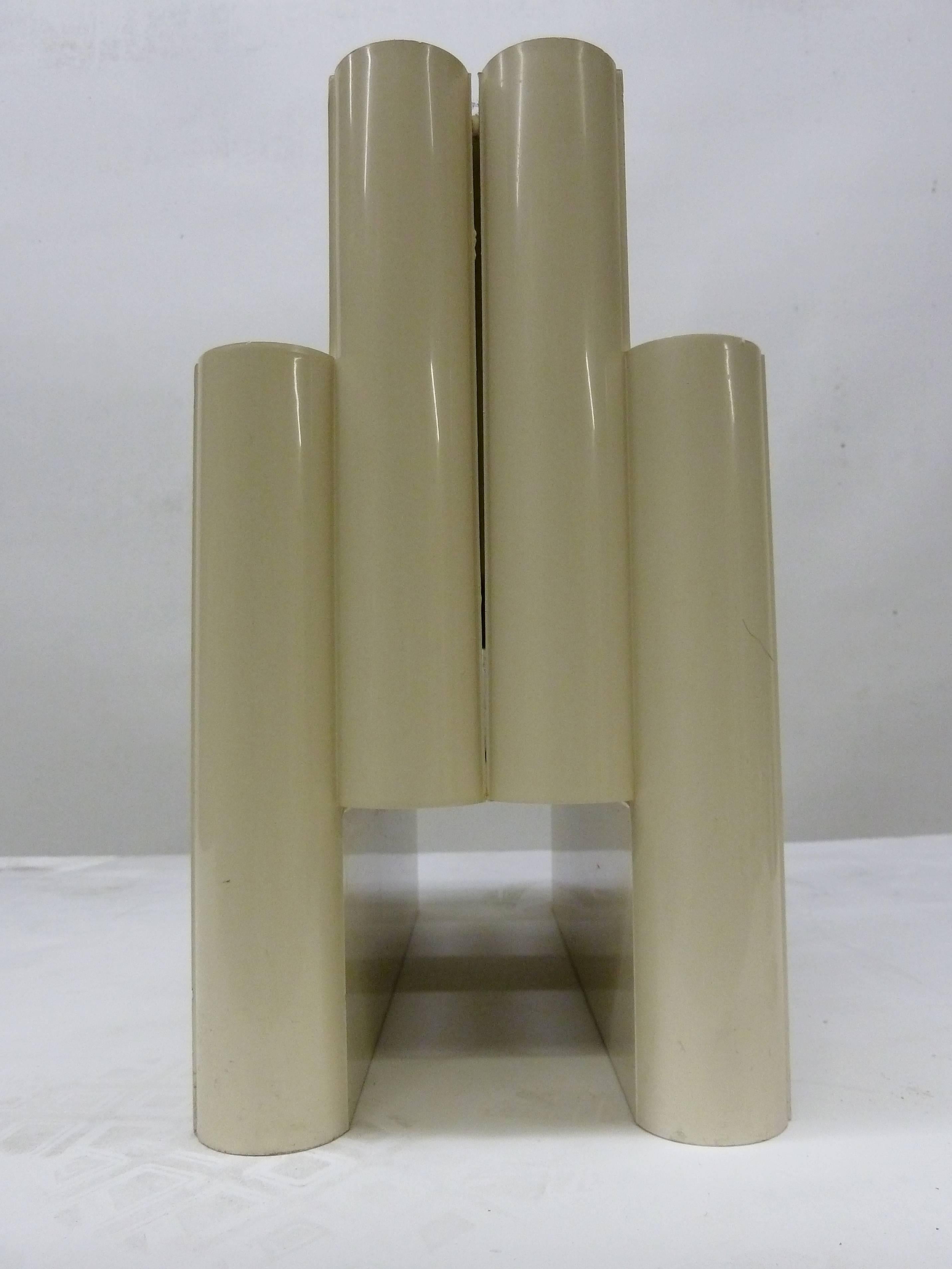 Beige plastic magazine or file holder has a distinct shape that seems to resemble an early 20th century skyscraper. Stamped on the bottom 
