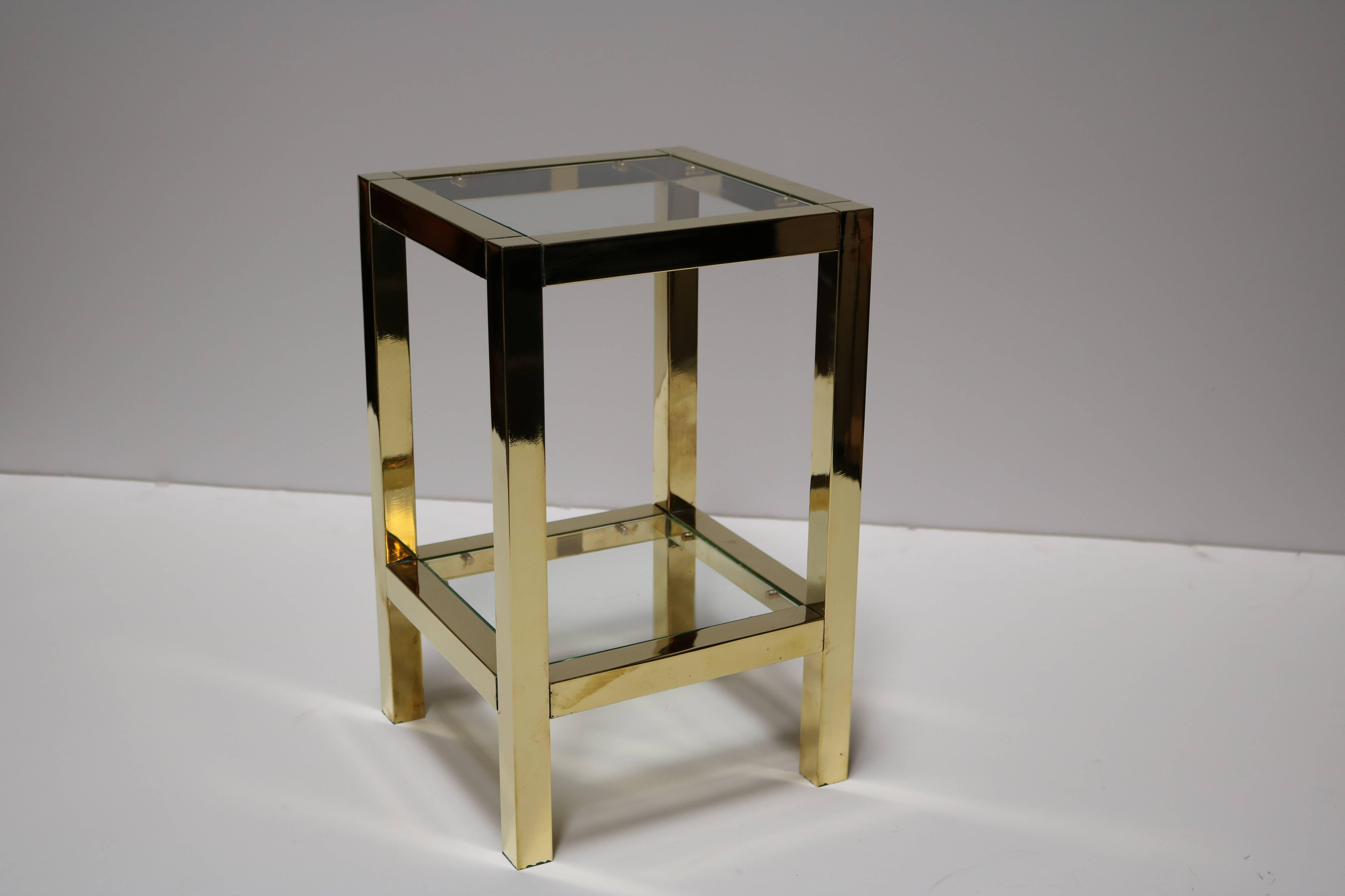 Low brass square shaped side tables each have two glass topped tiers. Tables have been newly refinished and all glass pieces are brand new.
They are perfect to display a tall sculpture.
       
