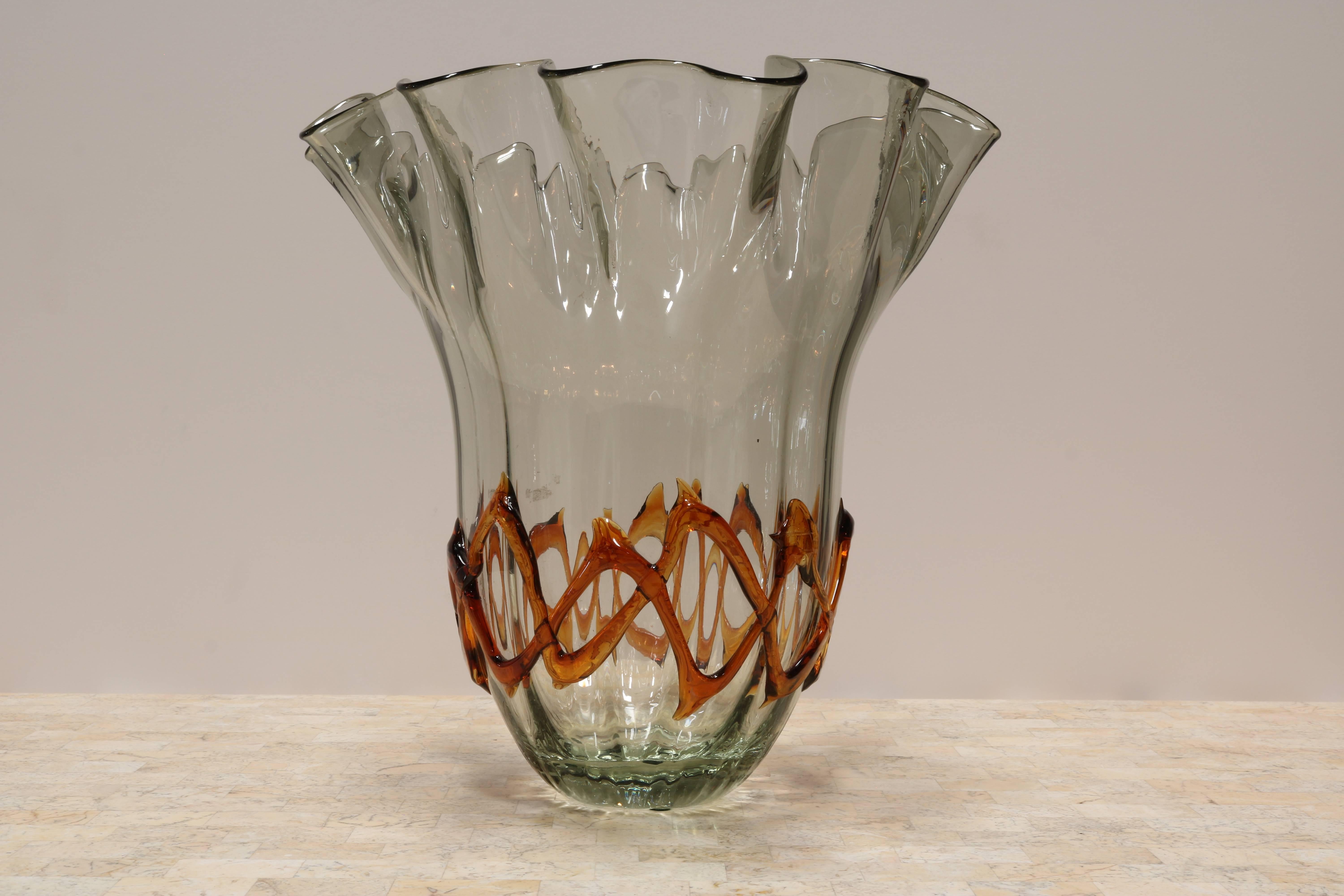 Fluted glass vase has a handkerchief edge and ribbons of amber colored glass around the bottom.